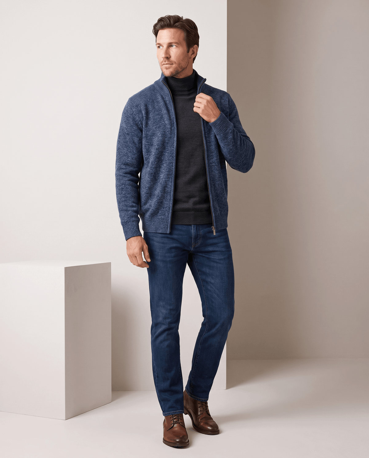 Full-length view of the navy cardigan with dark tee, jeans and brown shoes