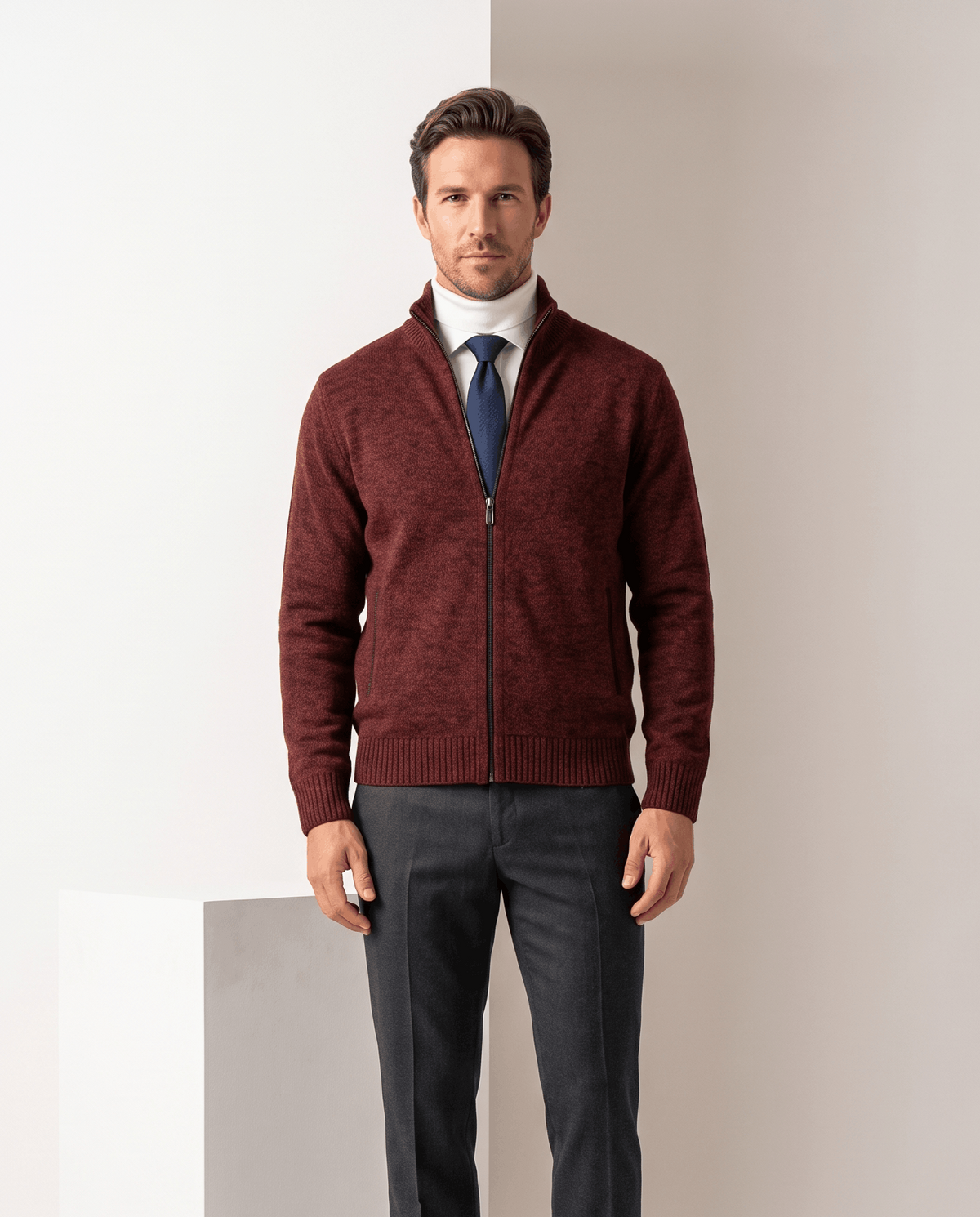 Red zip-up cardigan layered over a white shirt and navy tie