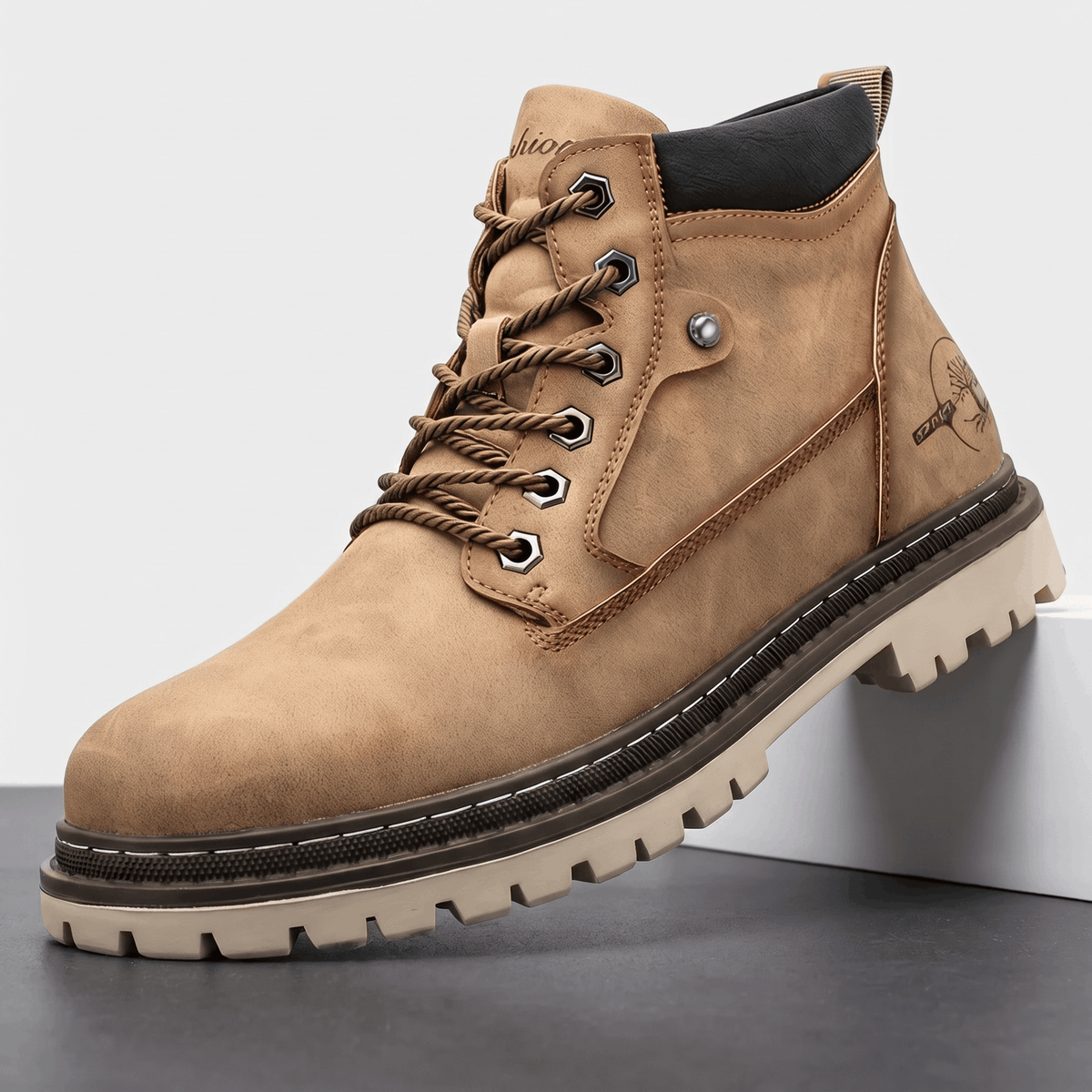Khaki matte grain lace-up work boot with a stitched welt, chunky lug outsole, and reinforced bolt-style hex eyelets.