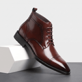 Polished dark brown leather brogue boots featuring a punched cap toe, five-eyelet lace-up closure, and slim rubber sole.