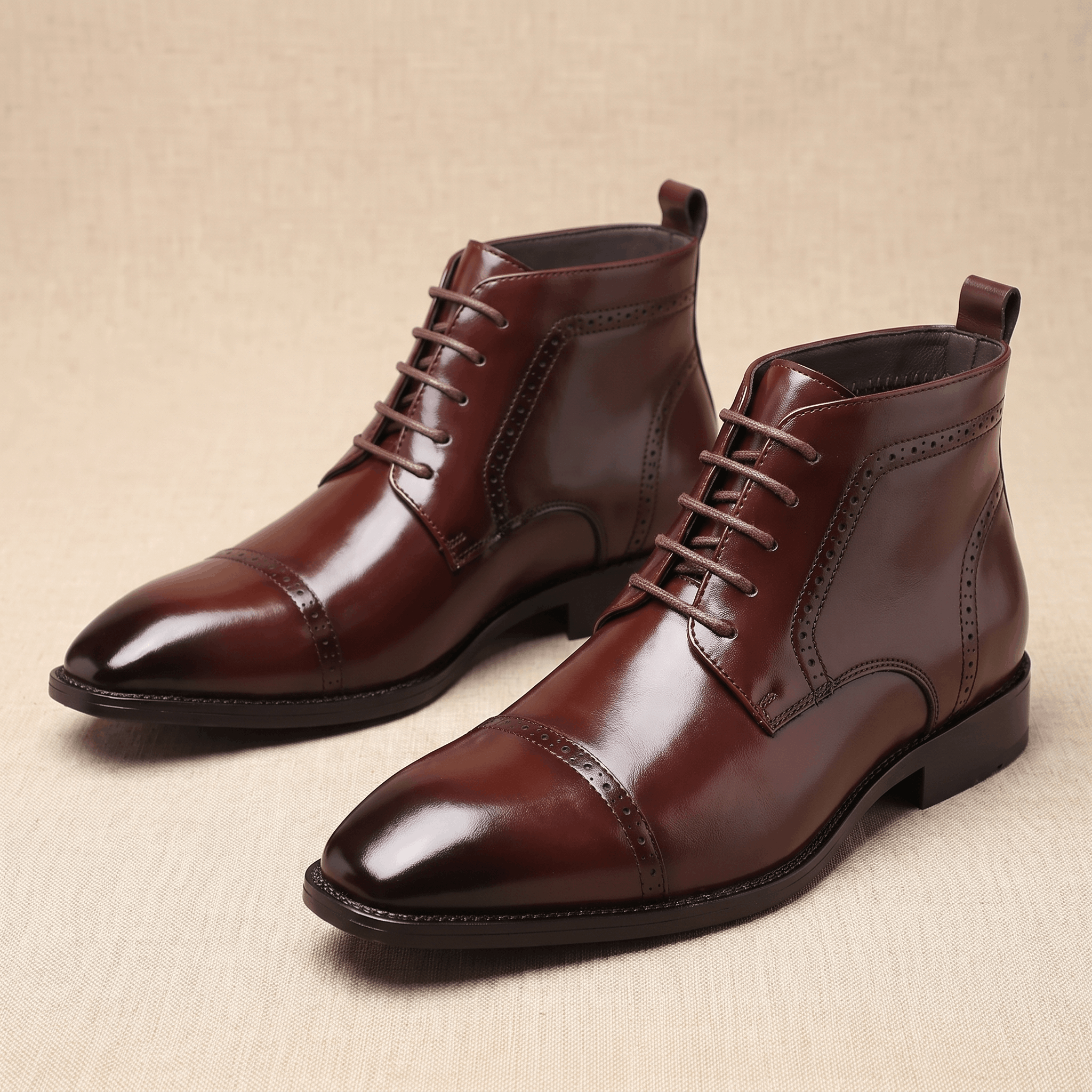 Polished dark brown leather brogue boots with a punched cap toe, five-eyelet lacing, and a slim rubber sole.
