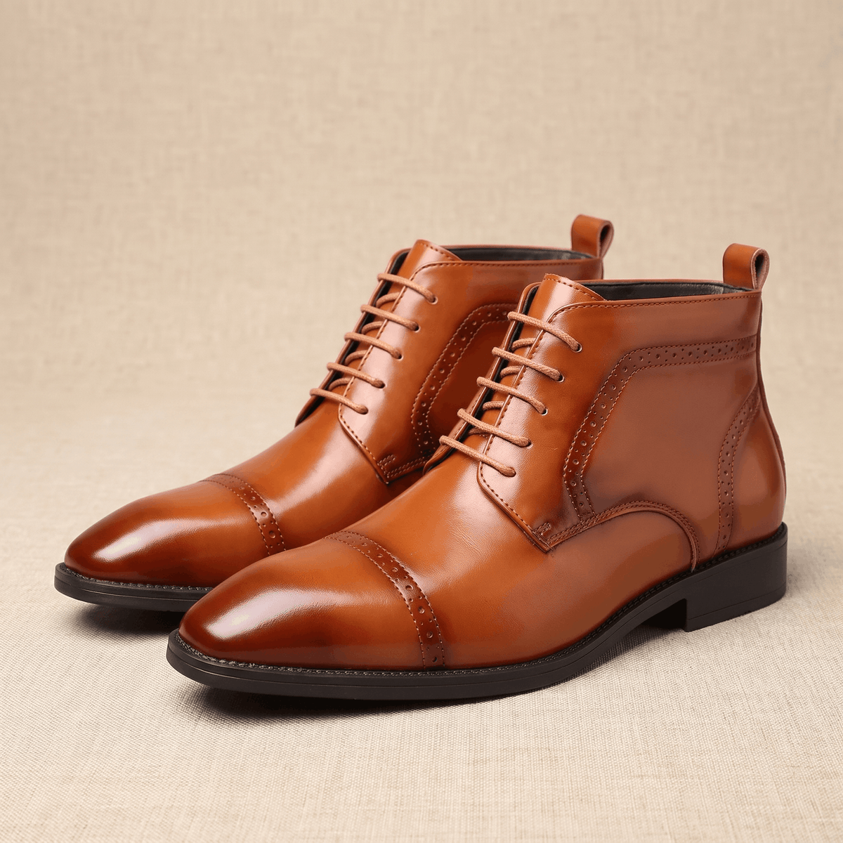 Brown leather brogue boots with a punched cap toe, five-eyelet lacing, and a slim non-slip rubber sole on a neutral background.