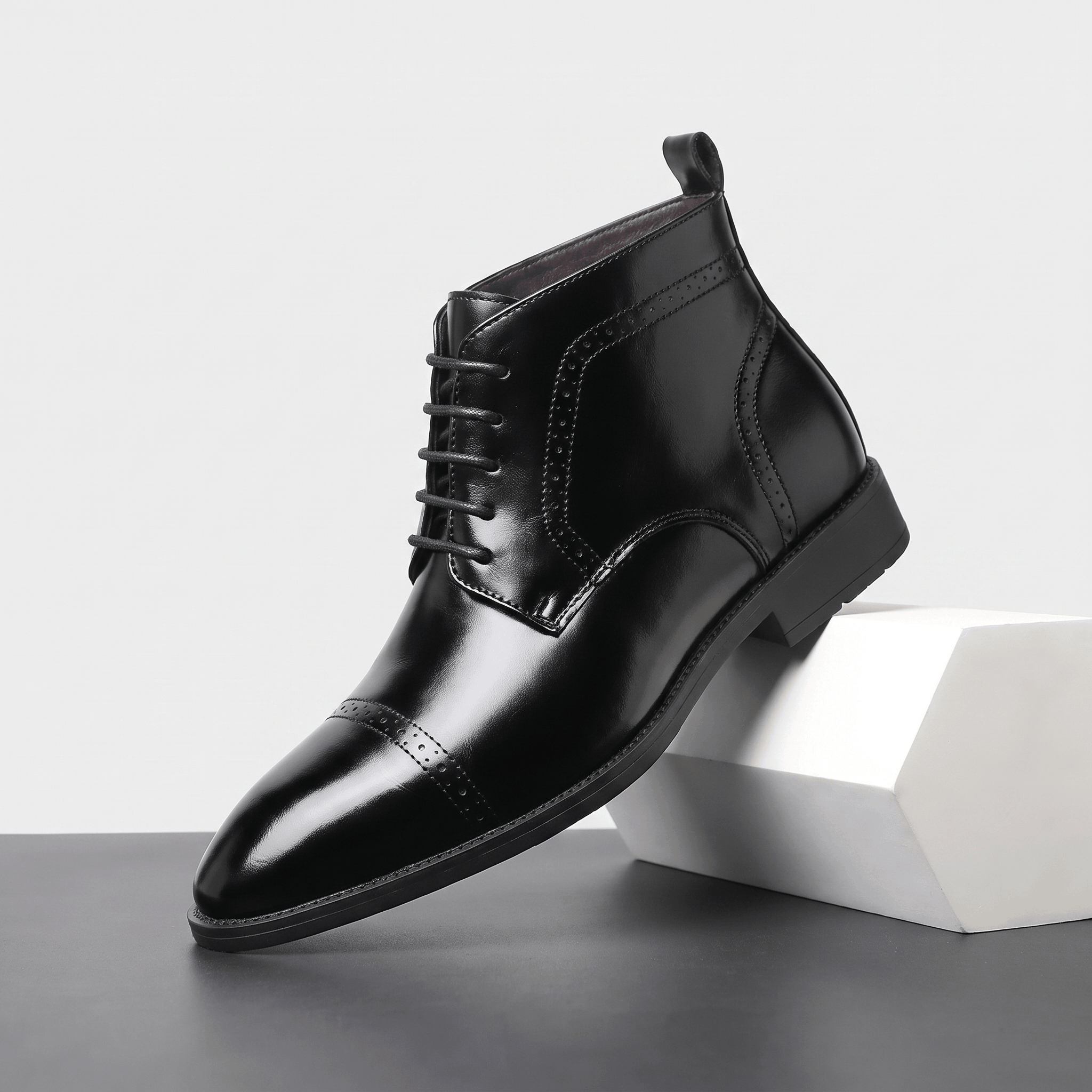 Black leather brogue boots with a punched cap toe, five-eyelet lacing, and a slim non-slip rubber sole.