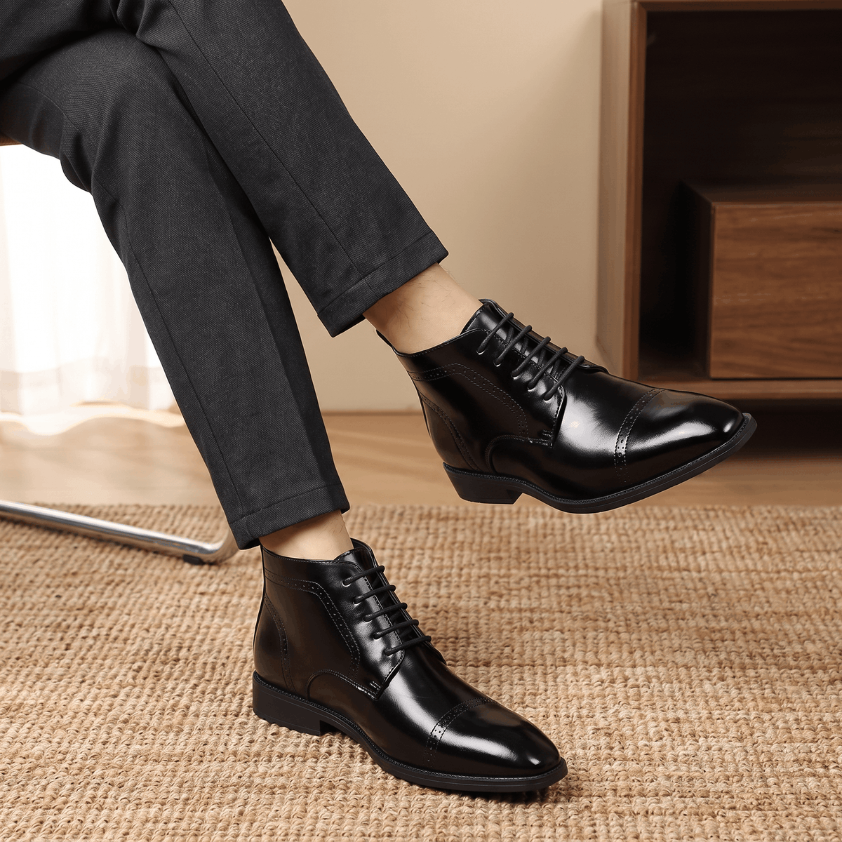 Polished black leather brogue boots featuring a punched cap toe, five-eyelet lacing, and a slim non-slip rubber sole.