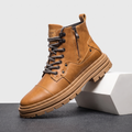 Tan leather combat boot with a reinforced cap toe, side zip, grey laces, and a chunky, lugged rubber platform sole.