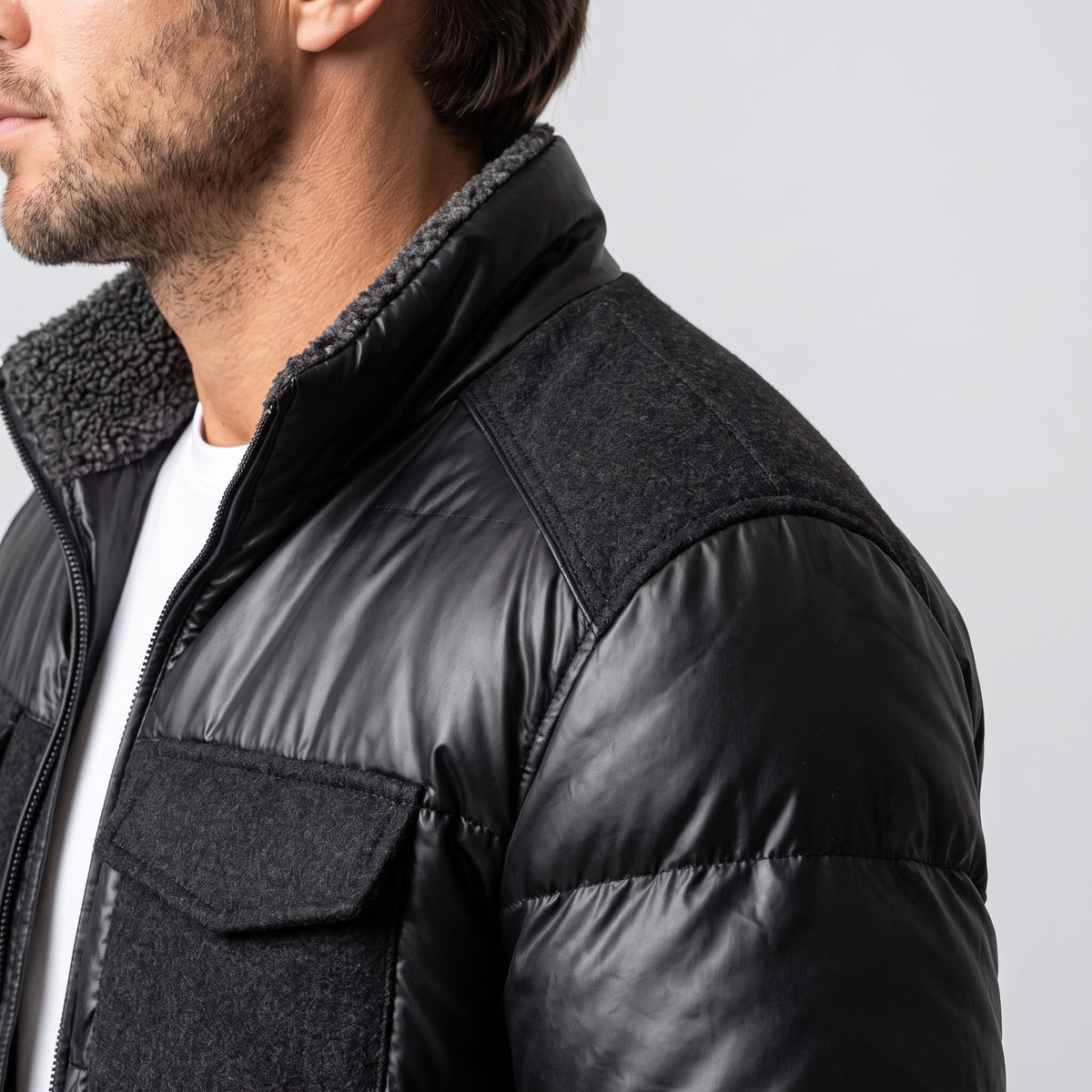 Detail of the black bomber sherpa-look collar lining and leather-look shoulder panel