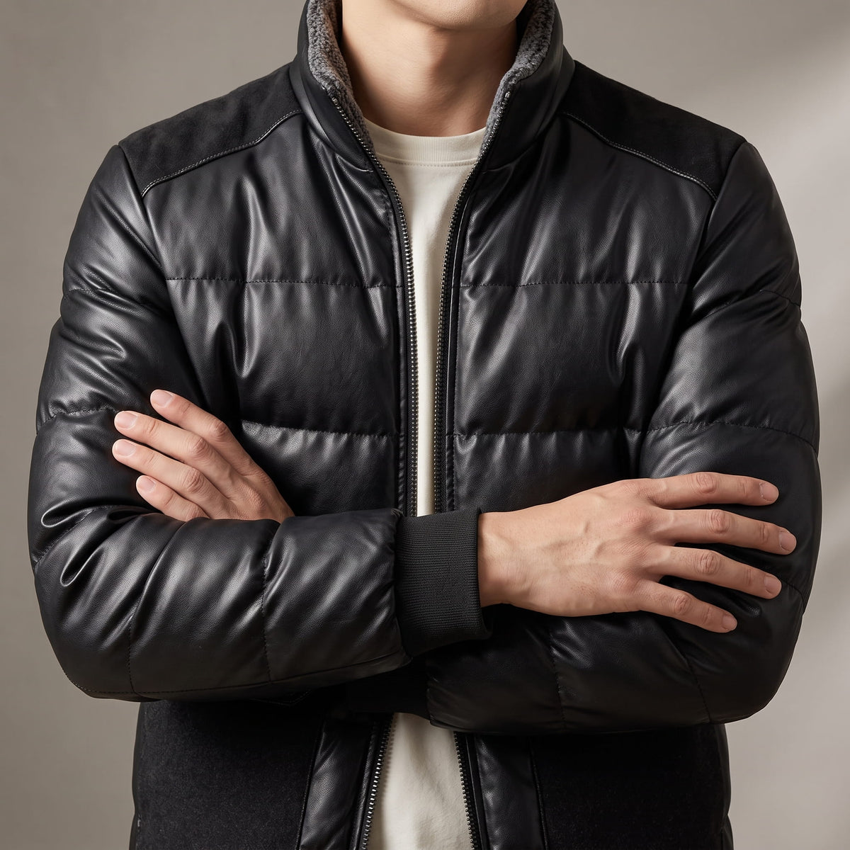 Close-up of the black bomber showing wide horizontal quilting and ribbed knit cuffs
