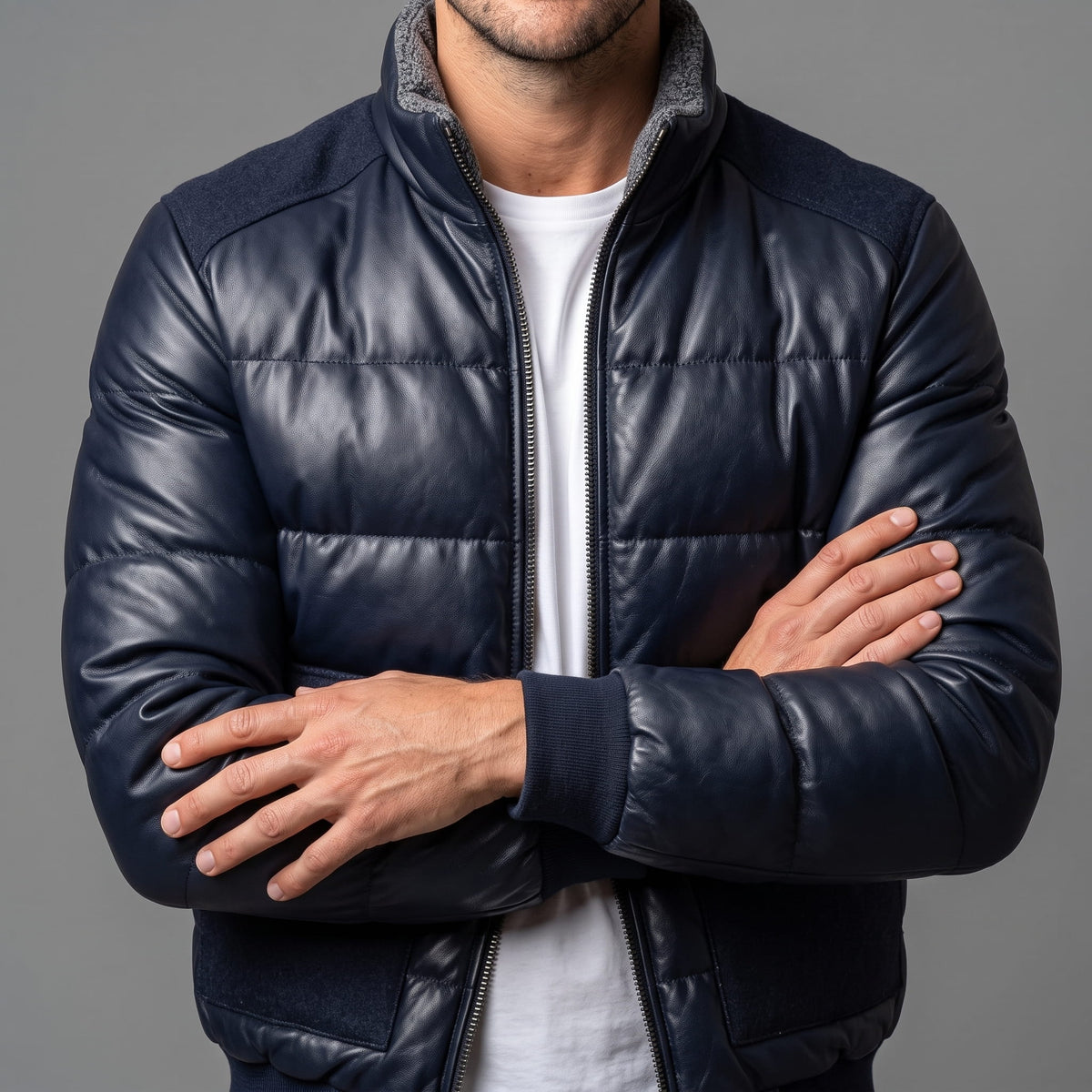 Blue Northstar leather-look bomber worn with arms folded, showing ribbed cuffs and front zip