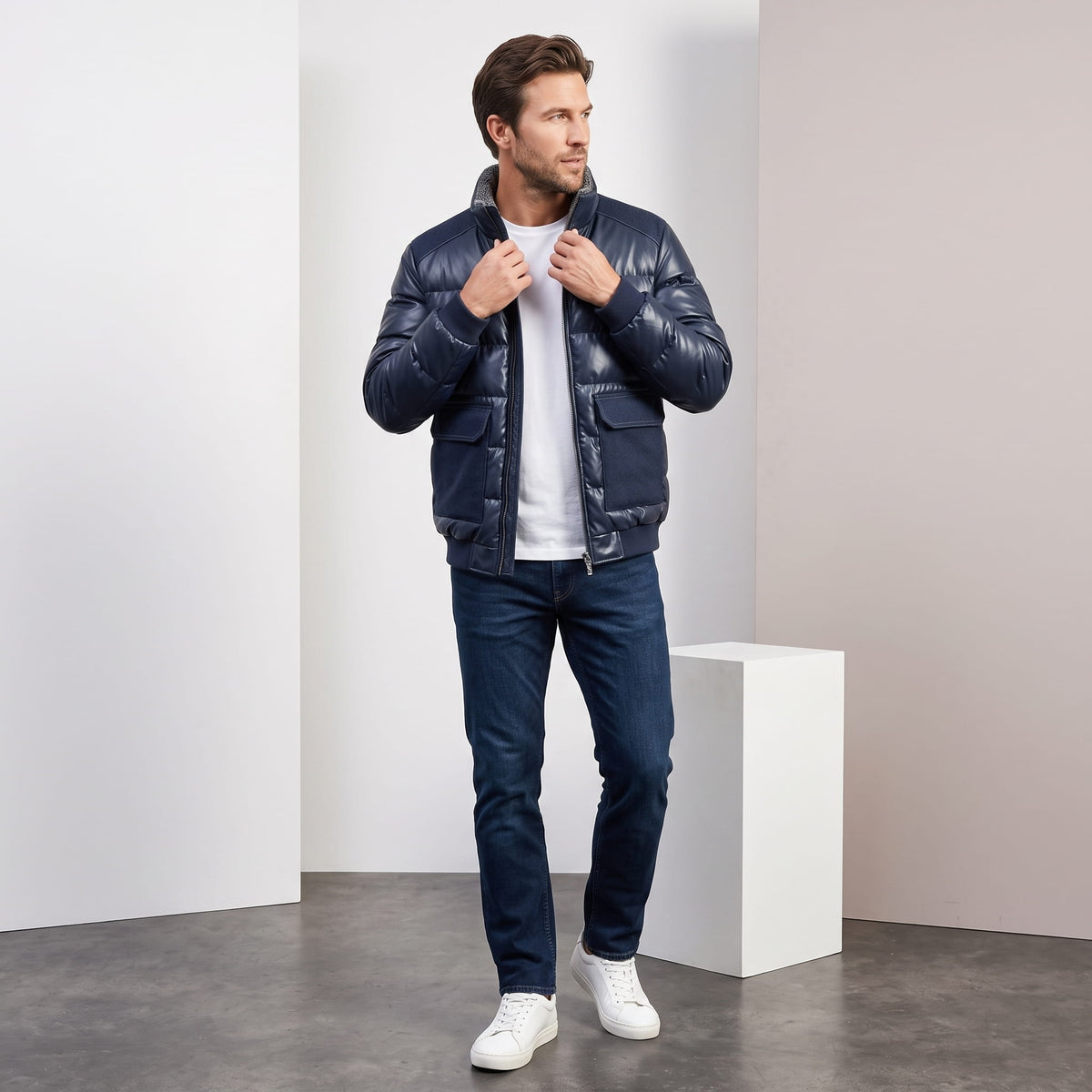 Full length view of a man wearing the blue Northstar leather-look bomber in a studio