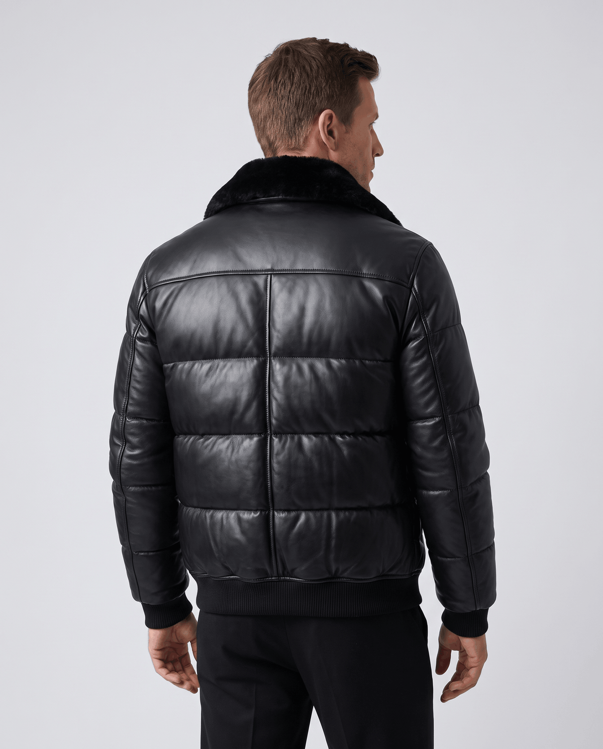 Back view showing four horizontal quilted panels and ribbed hem at the waist