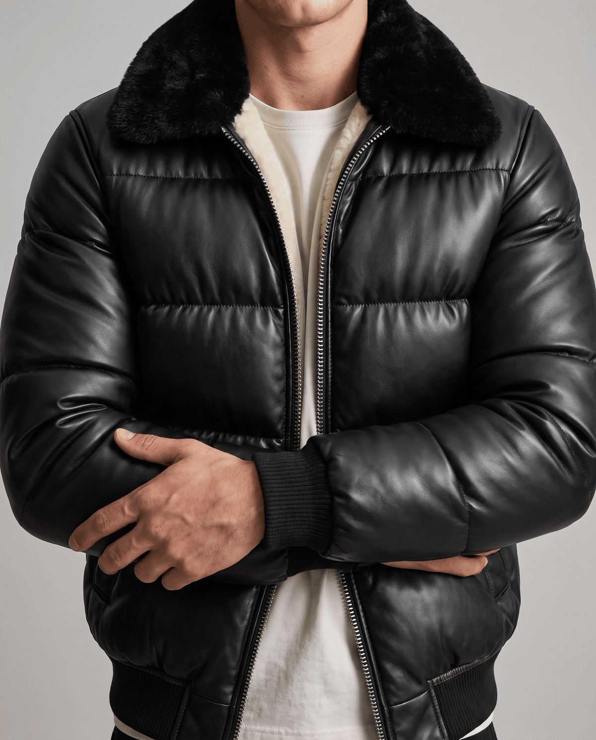Close torso view of quilted horizontal panels, ribbed cuff and two-way front zip