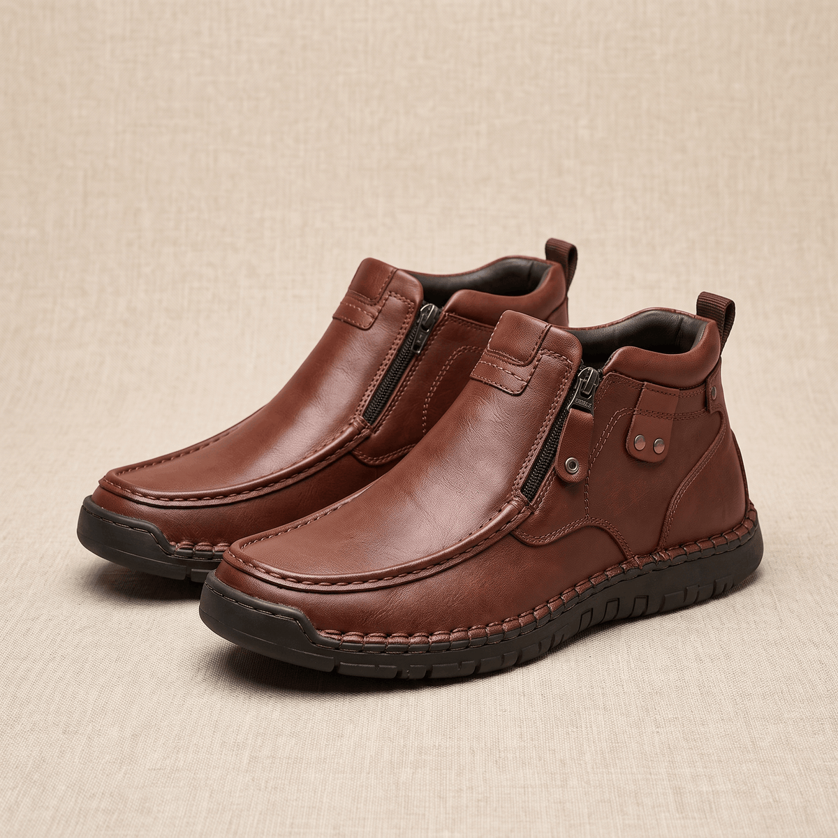 Dark brown leather moc toe boots featuring a side zip, whipstitched rubber midsole, and apron seam on a textured background.