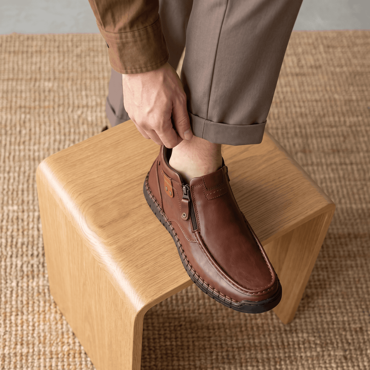 Dark brown leather moc toe boots with side zip entry, apron seam detailing, and a whipstitched rubber midsole.