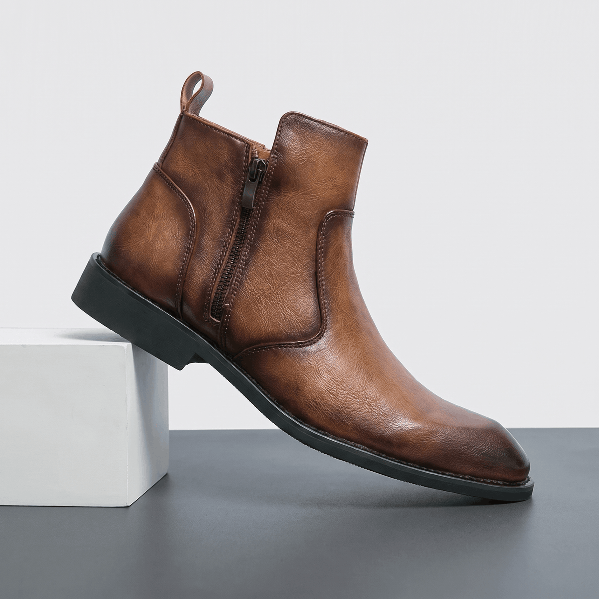 Burnished brown leather dress boot with a pointed toe, inside zip closure, and a slim stacked block heel.
