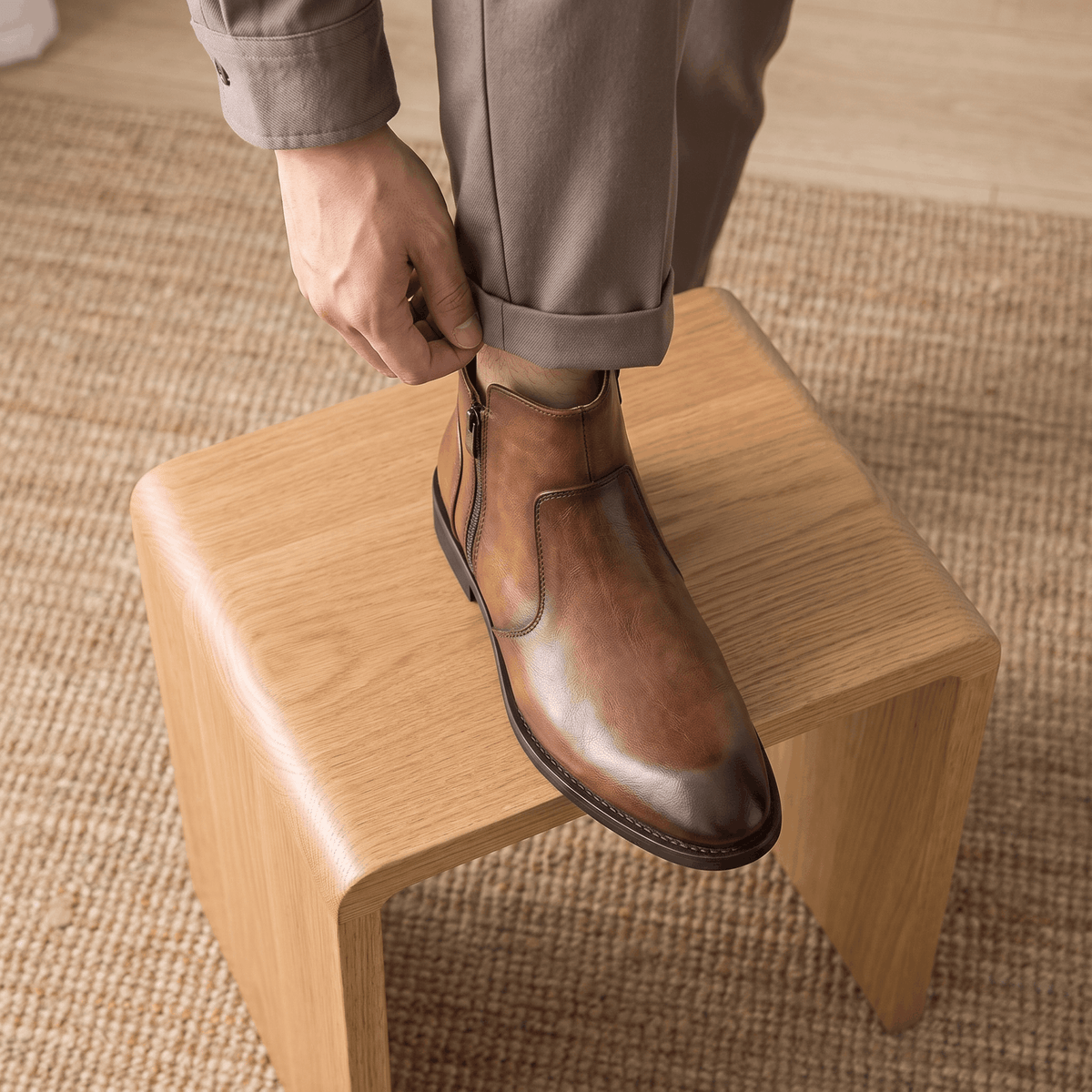 Burnished brown leather dress boot with a pointed toe, slim stacked heel, and discreet inside zip closure.
