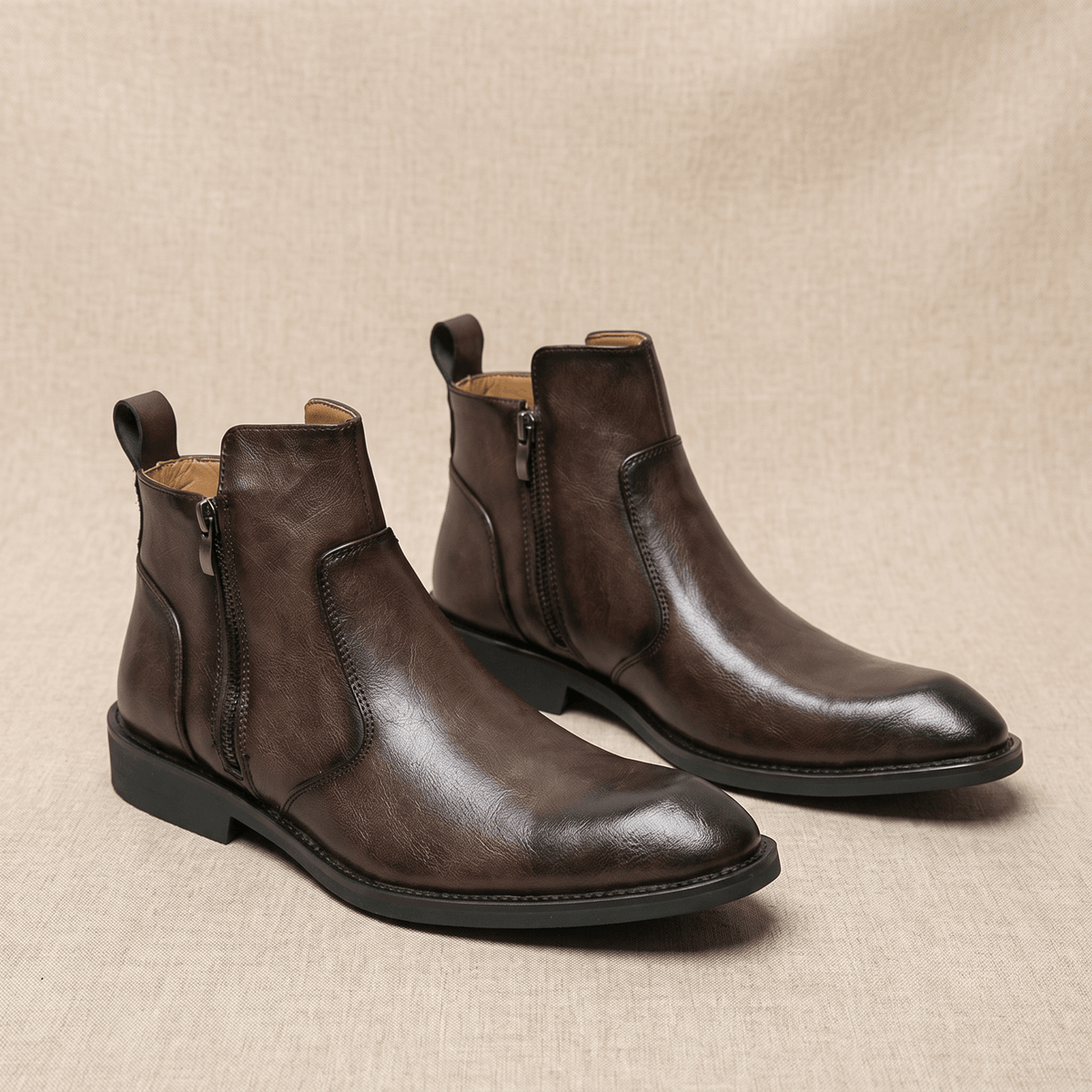 Burnished dark brown leather dress boots with a pointed toe, inside zip closure, and a slim, low stacked block heel.