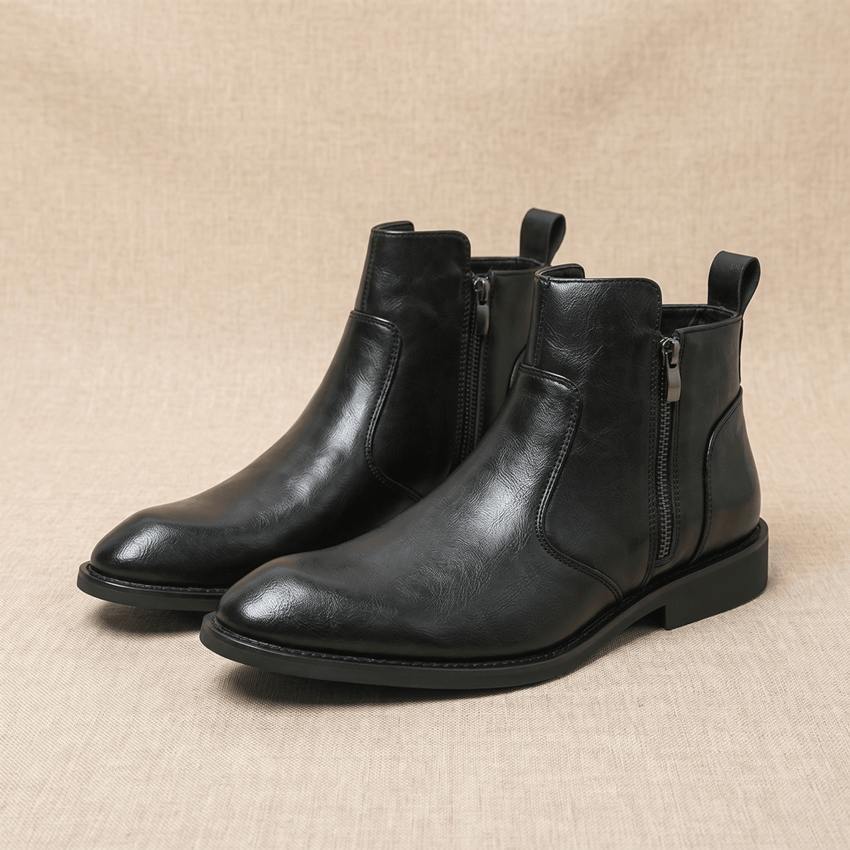 Black burnished leather dress boots with a pointed toe, inside zip closure, and a low stacked block heel.
