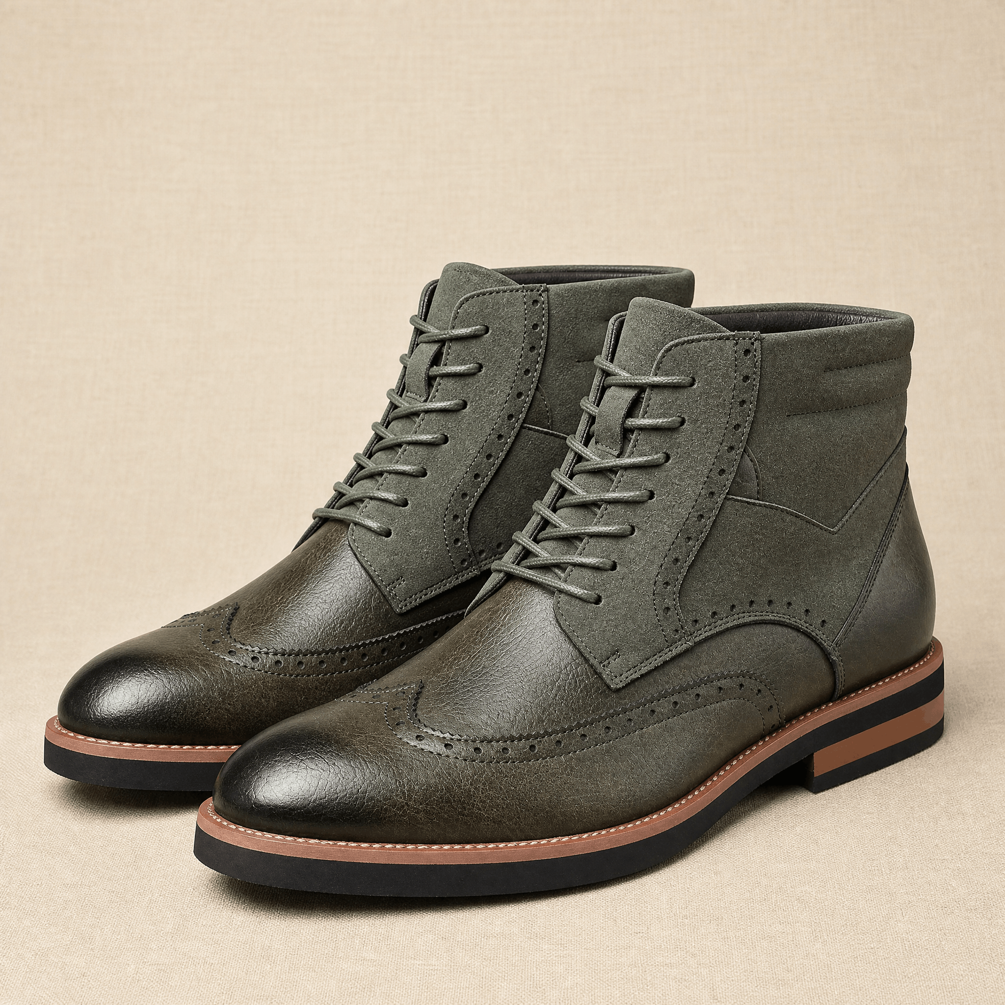 Dark gray wingtip brogue ankle boots featuring a smooth leather vamp, suede shaft panel, and a sturdy welted rubber sole.