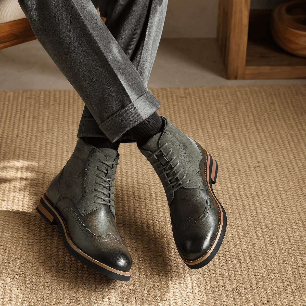 Gray leather wingtip brogue ankle boots featuring a suede shaft panel, burnished toe, and a sturdy welted rubber sole.