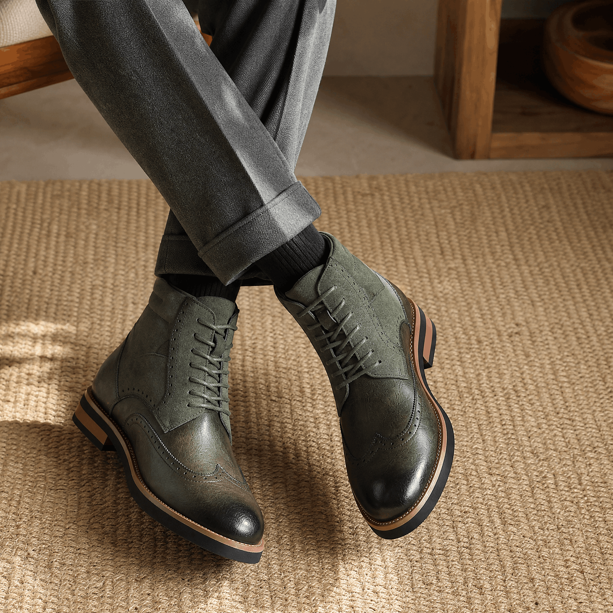 Gray leather wingtip brogue ankle boots featuring a suede shaft panel, burnished toe, and a sturdy welted rubber sole.