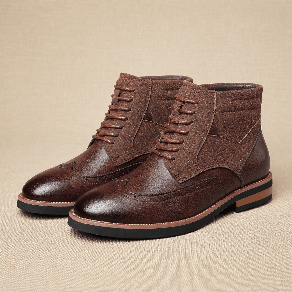 Dark brown leather wingtip ankle boots with suede shaft panels, brogue detailing, and a durable welted rubber sole.