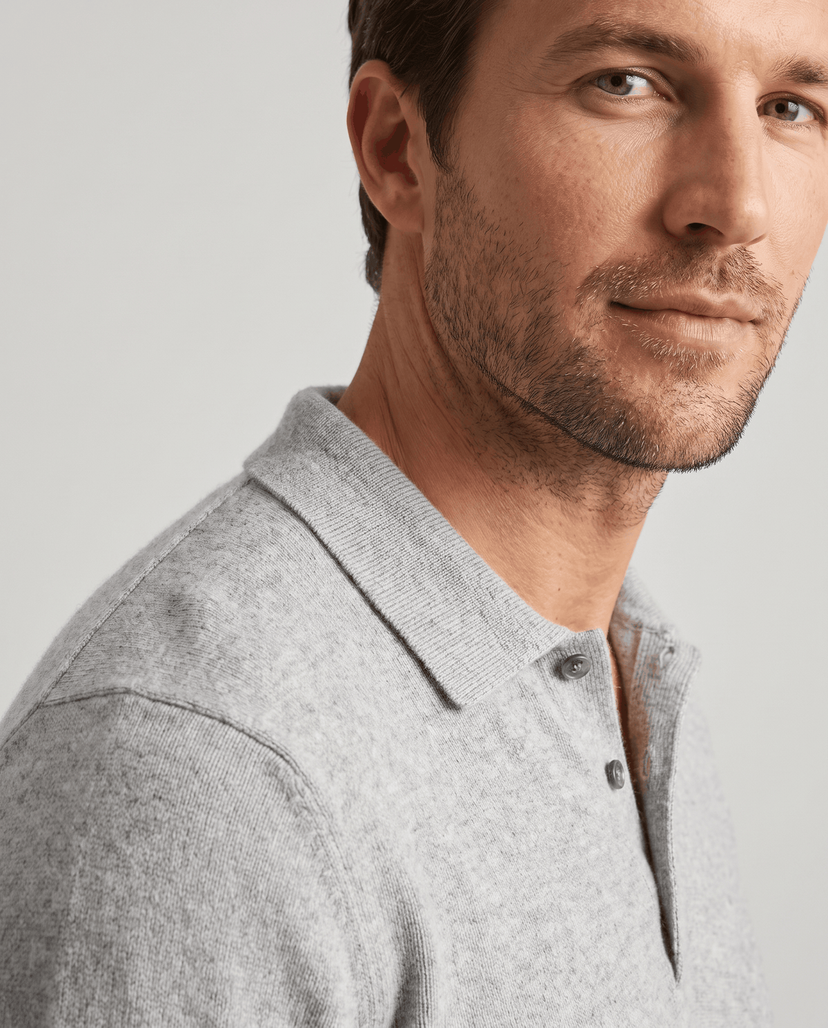 Close-up of the collar and button placket on the Elias light gray wool knit polo sweater