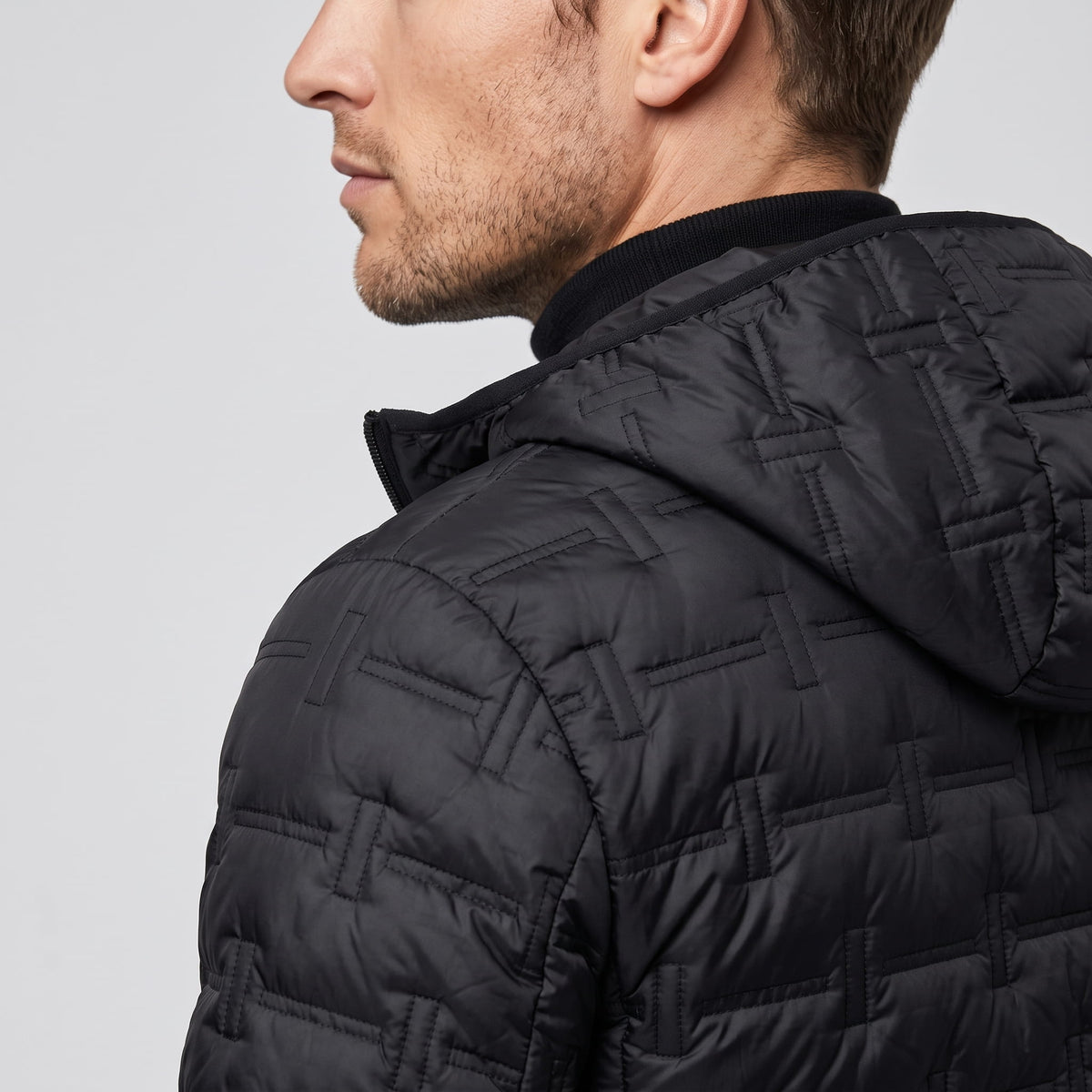 Close detail of the black hood against the basketweave quilted shoulder