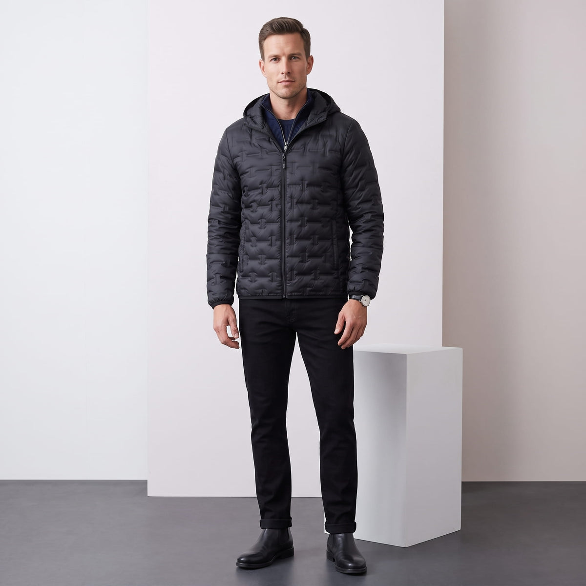 Black jacket styled full-length with dark trousers and black boots