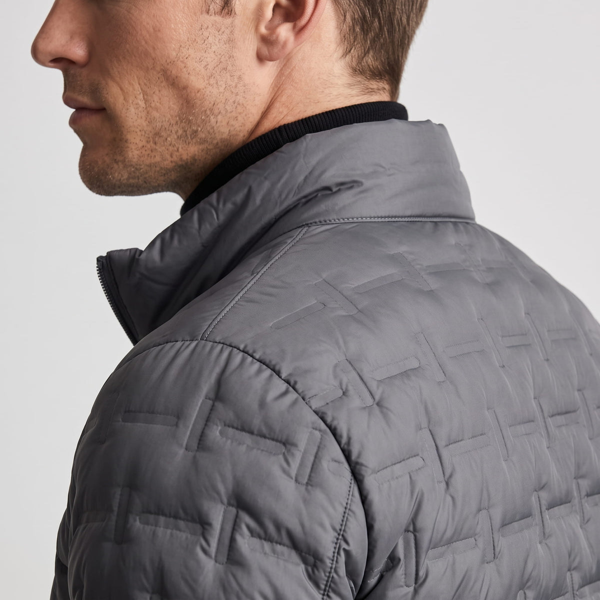 Close detail of the gray stand collar and the offset block quilting