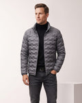 Man wearing gray lightweight down puffer jacket with basketweave quilting