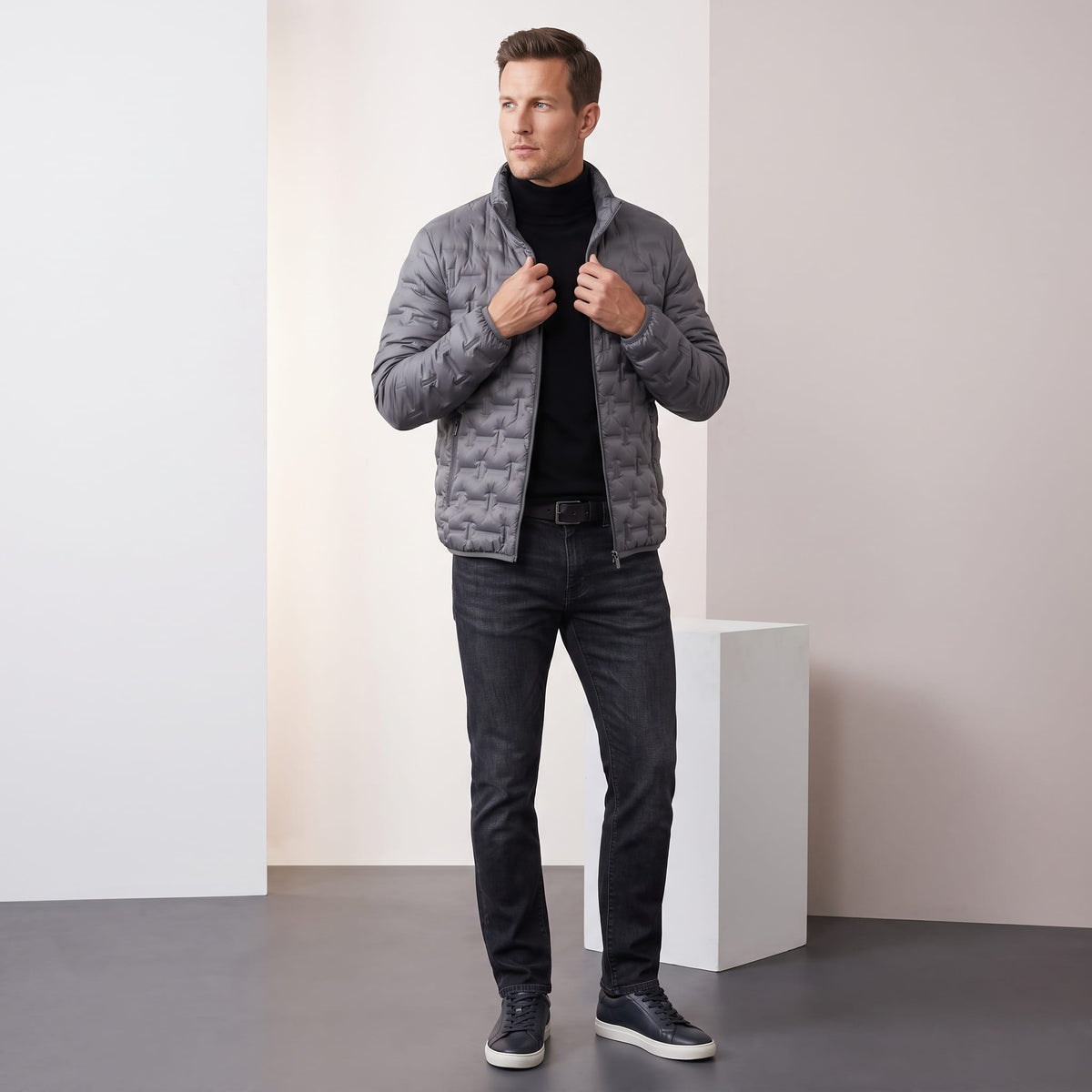 Gray jacket styled full-length over a turtleneck with dark jeans