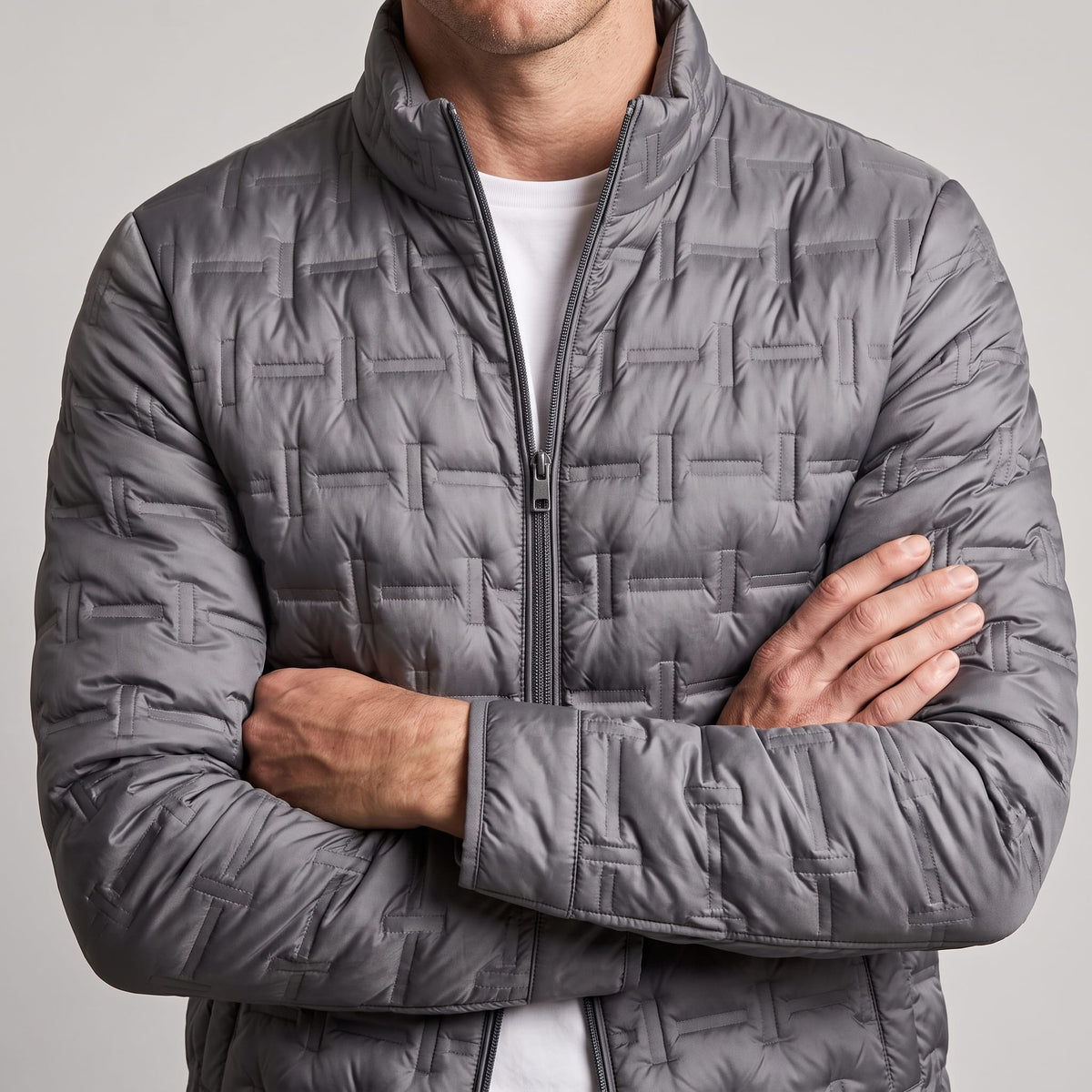 Gray torso with arms crossed, slim sleeves and low-bulk quilted panels