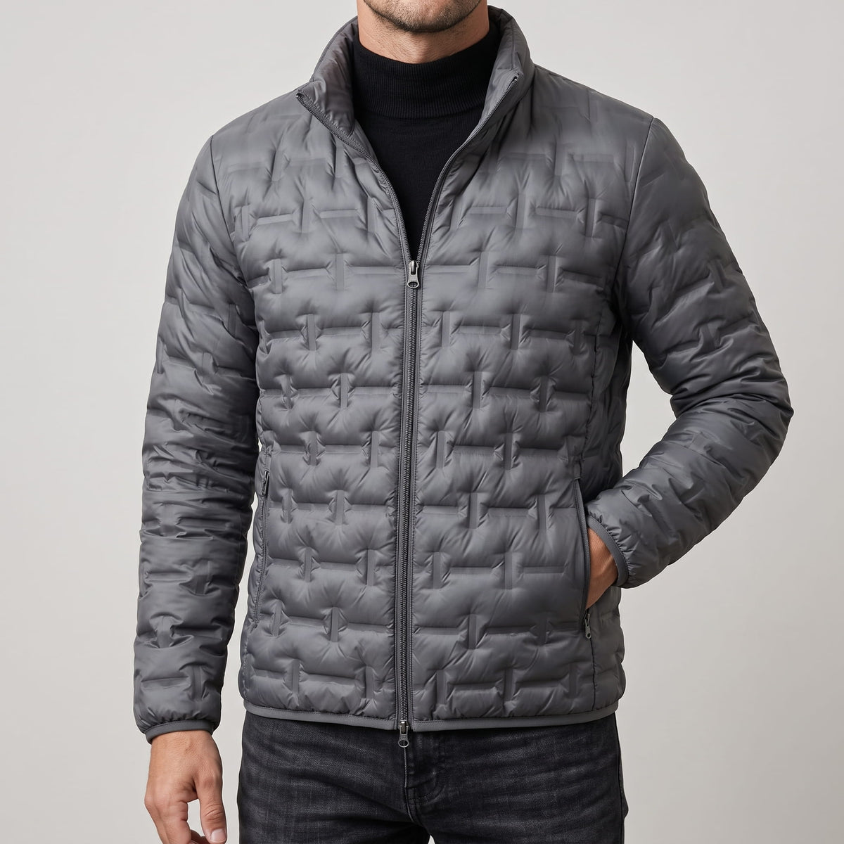 Gray jacket zipped, showing the stand collar and offset quilted blocks