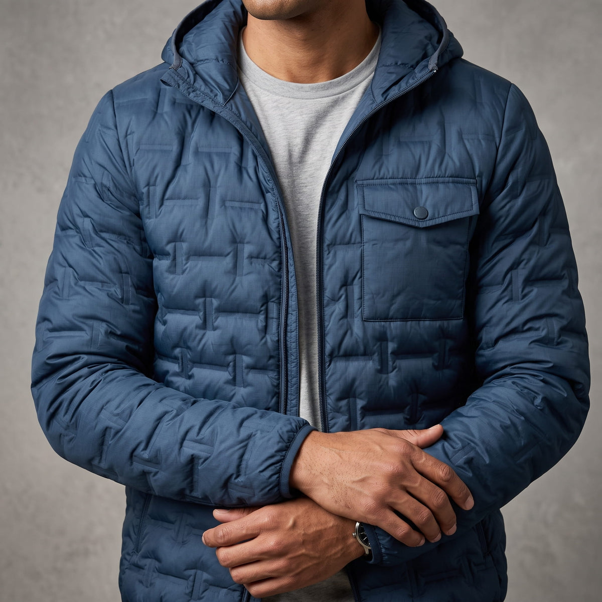 Navy jacket showing hood, chest flap pockets and basketweave quilting