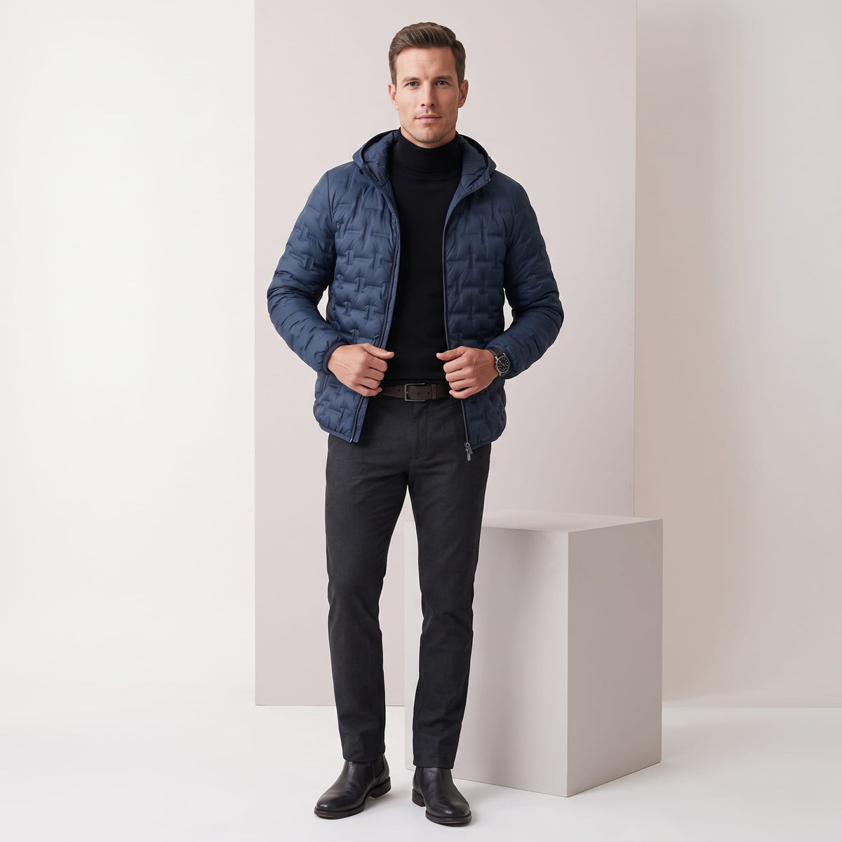Navy jacket styled full-length with black trousers and Chelsea boots