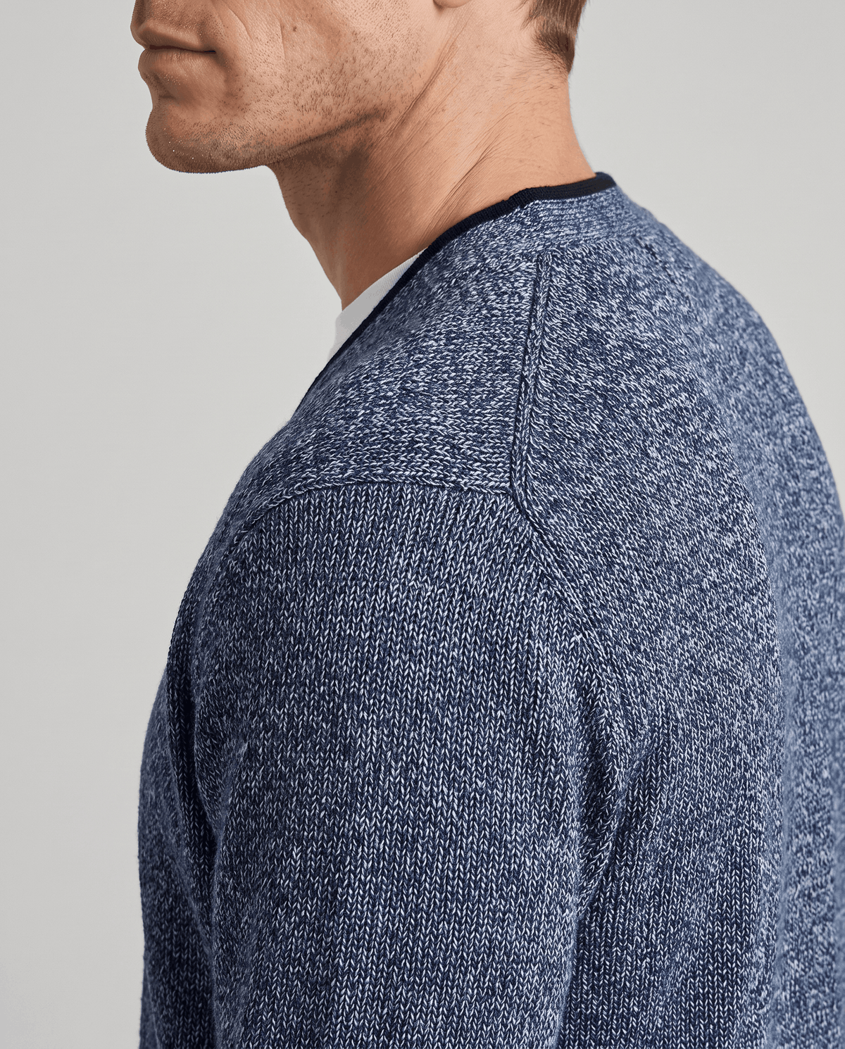Side profile of the blue two-tone knit at the shoulder and neckline