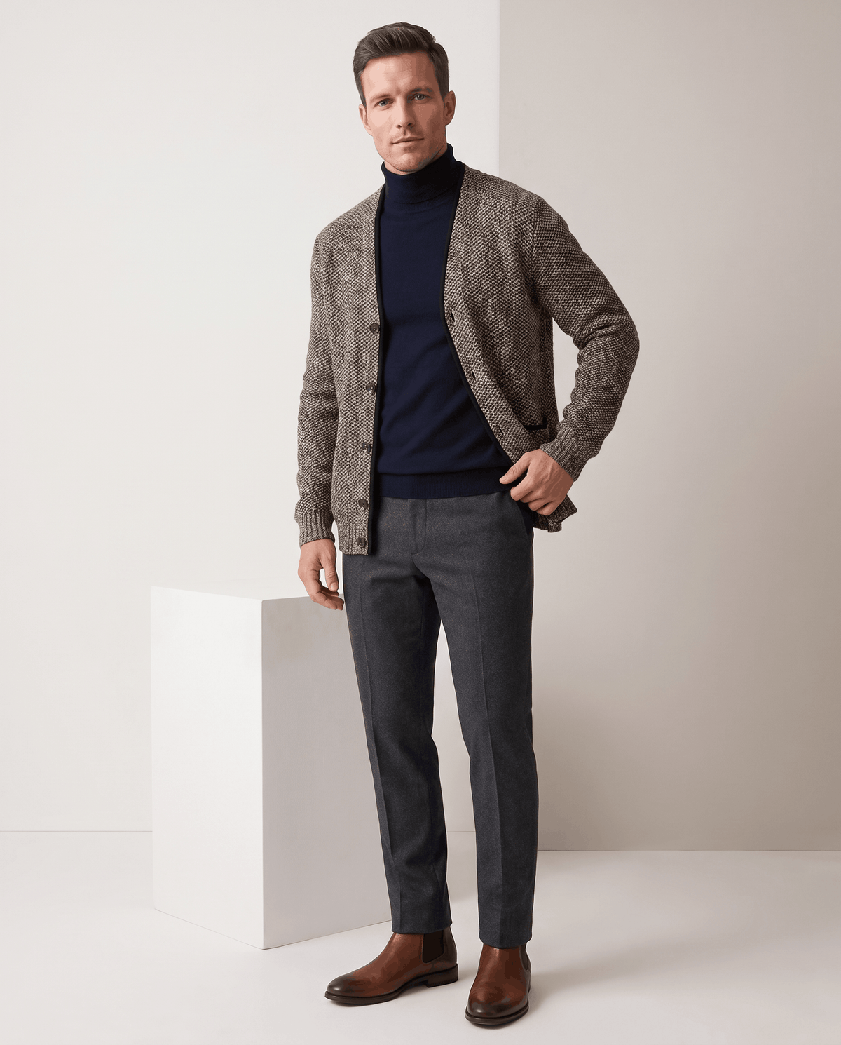 Full-length view of the brown cardigan with a navy turtleneck and gray trousers