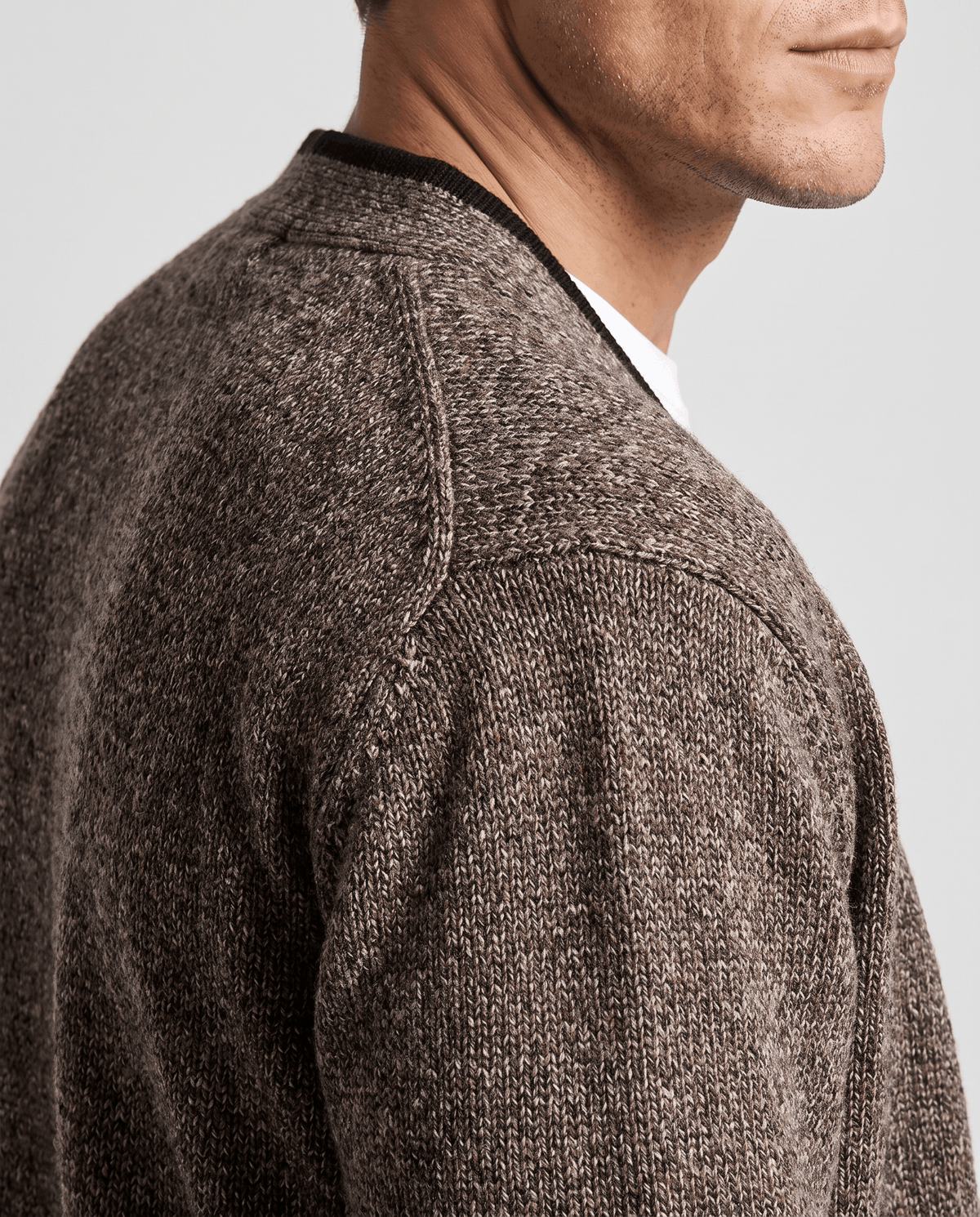 Close-up of the brown two-tone knit texture at the shoulder