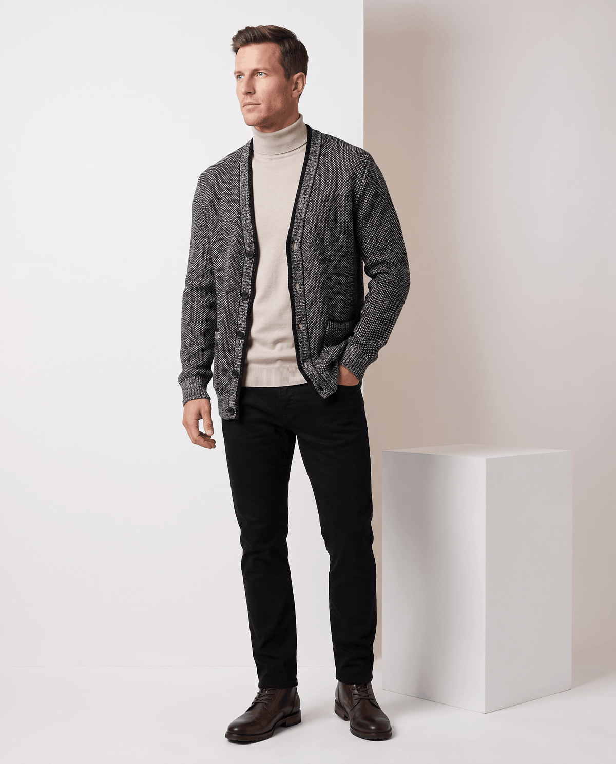 Dark gray marled cardigan styled over a cream turtleneck