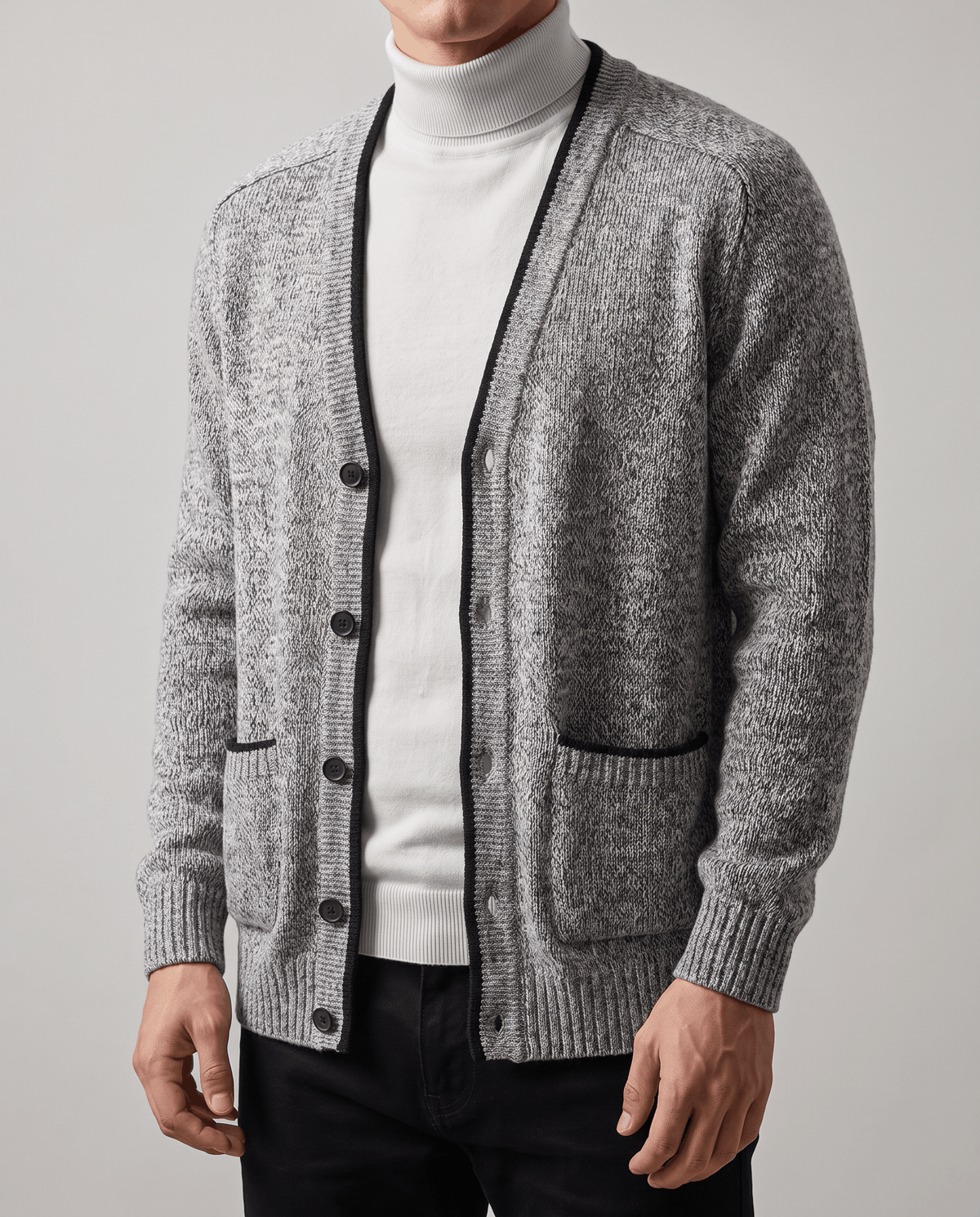 Close-up of the light gray cardigan buttoned over a white turtleneck