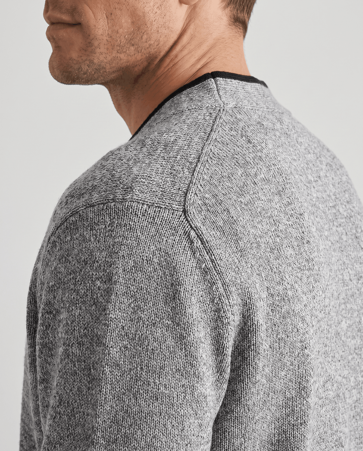 Side close-up of the light gray marled knit at the shoulder