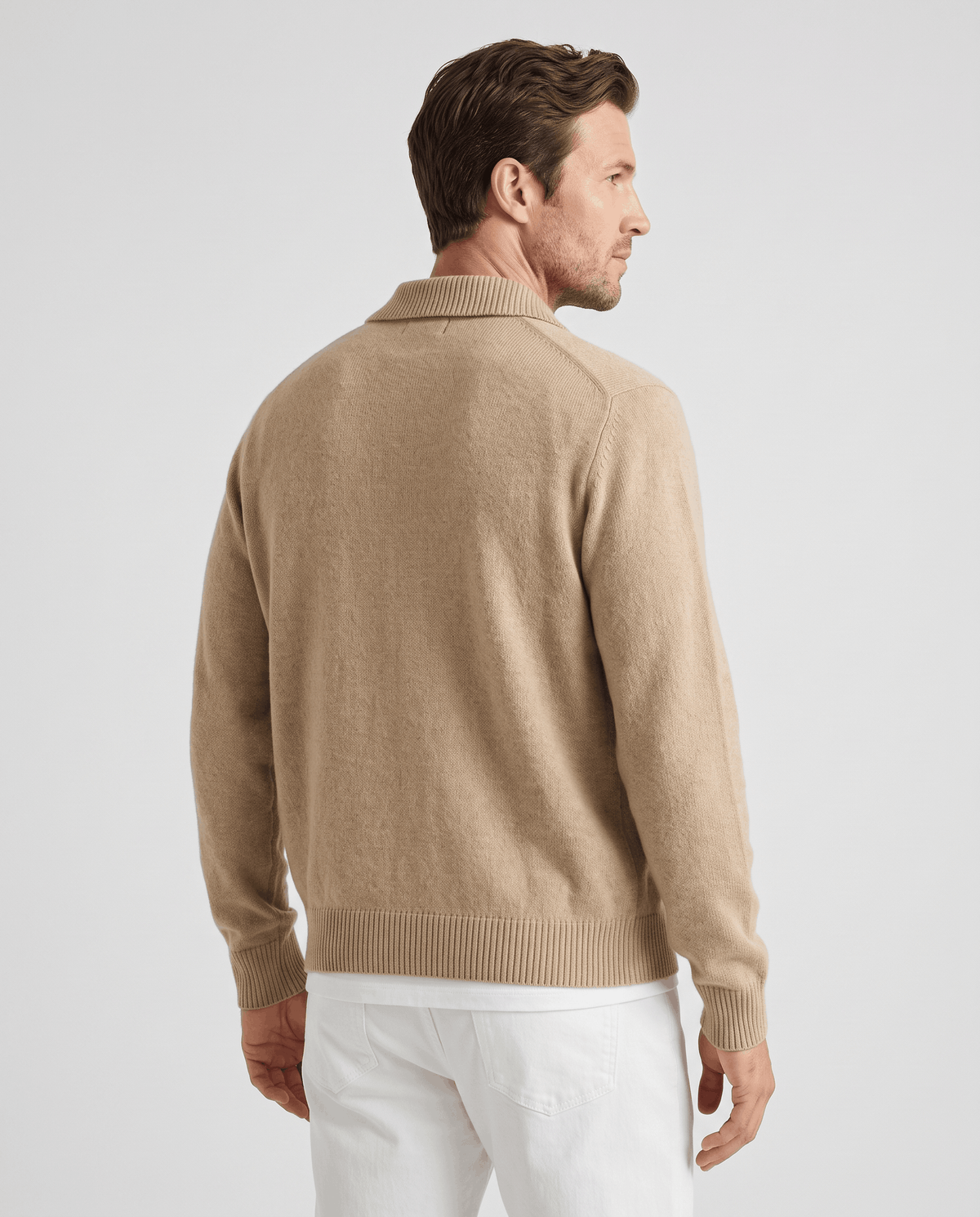 Back view of the camel cardigan with white trousers