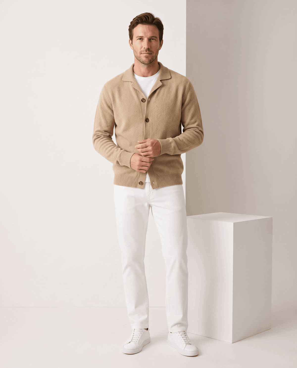 Full-length view of the camel cardigan with white trousers and white sneakers