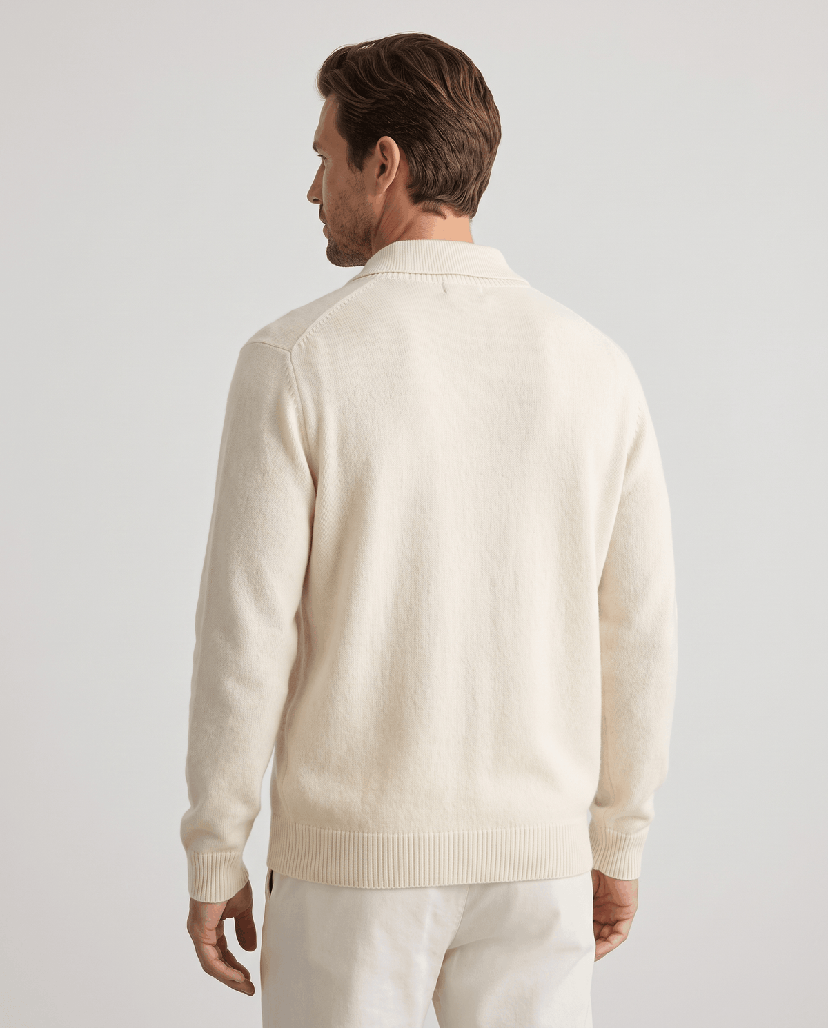 Back view of the ivory button-front cardigan with ribbed hem