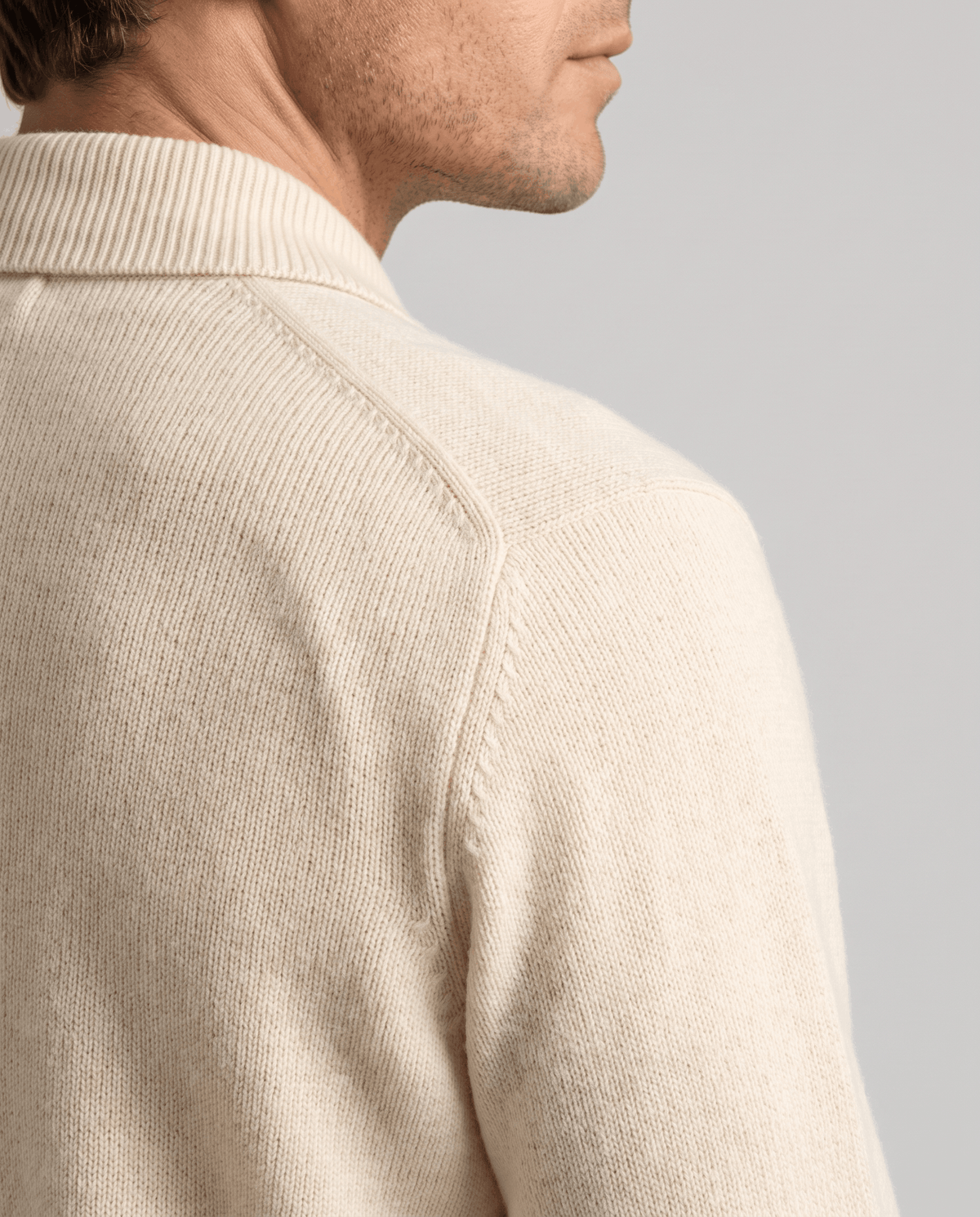 Side close-up of the ivory cardigan knit at the shoulder and collar