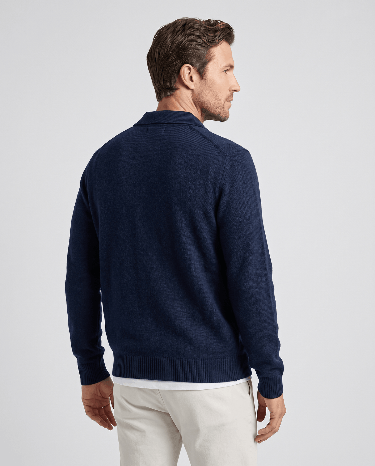 Back view of the navy button-front cardigan with ribbed hem