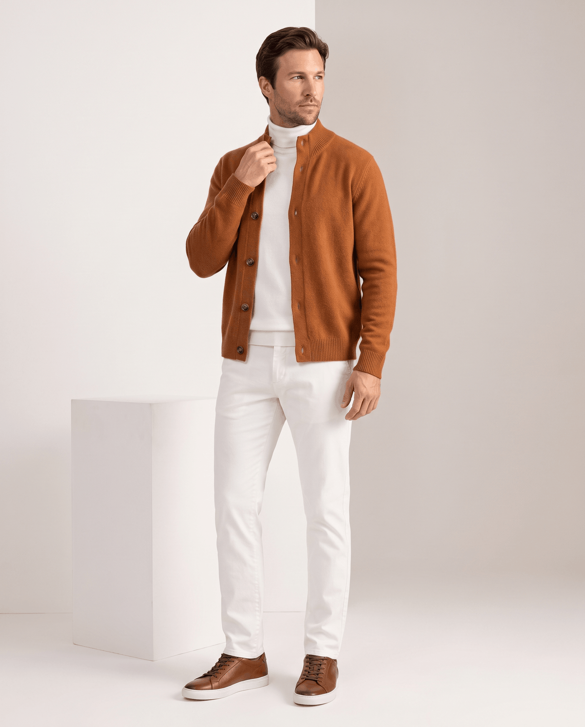 Full-length view of the orange cardigan with white trousers and brown shoes