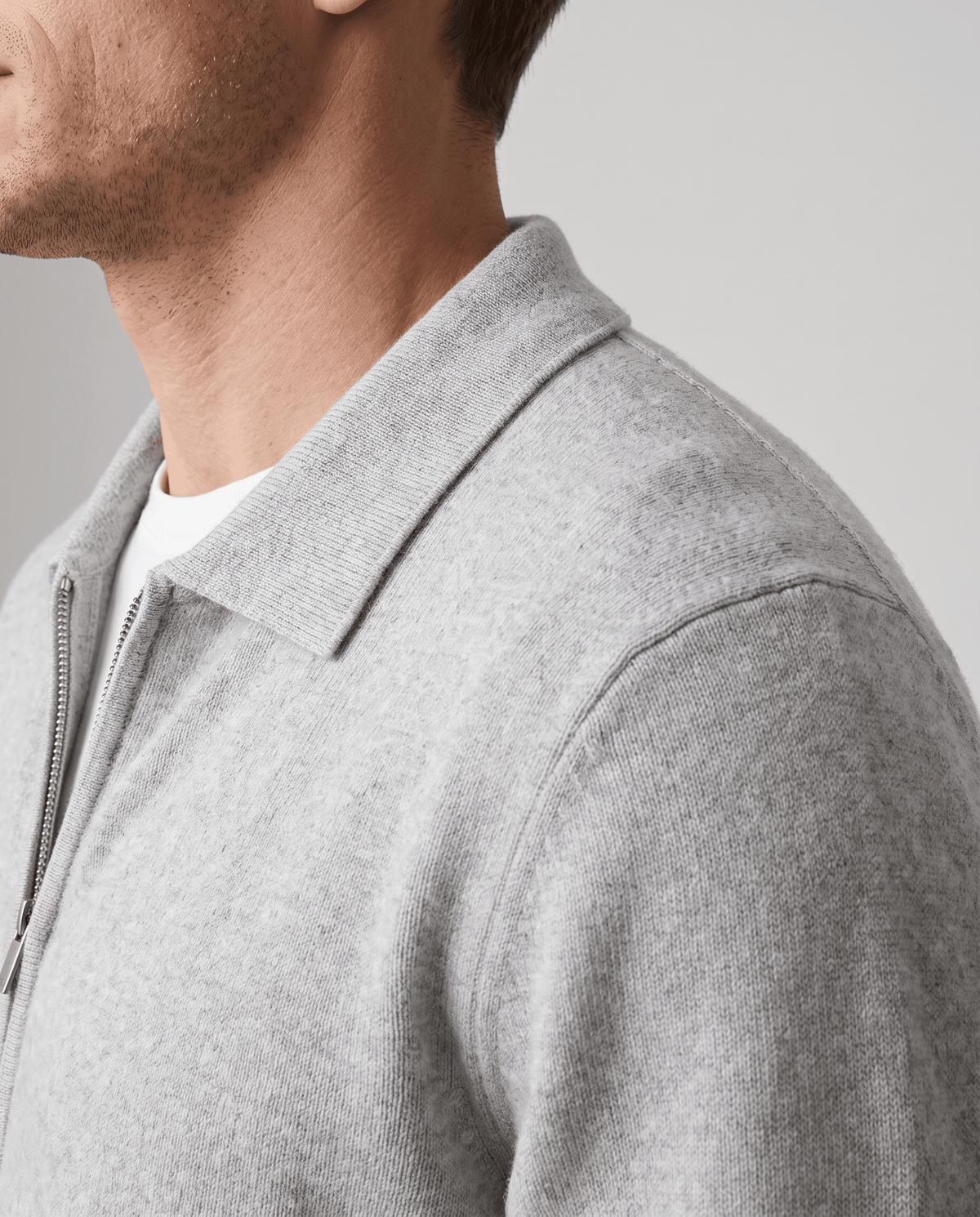 Side close-up of the light gray cardigan shirt collar and fine knit