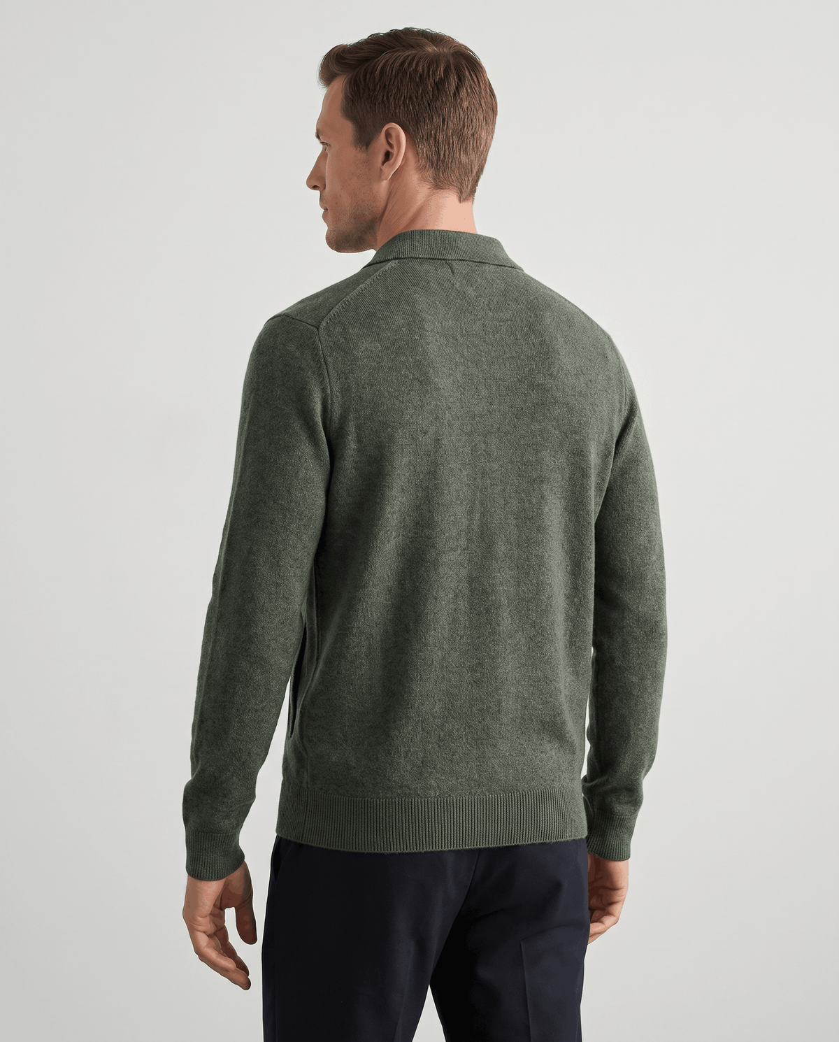Back view of the olive green zip-up cardigan with ribbed cuffs
