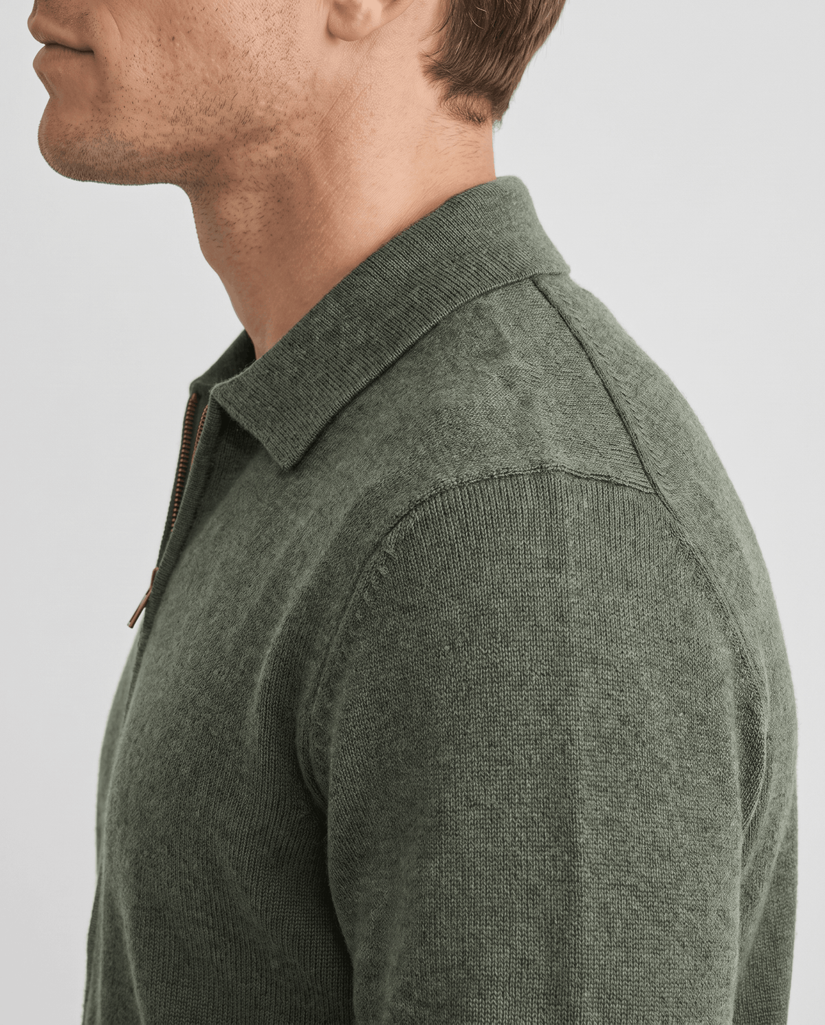 Side close-up of the olive green cardigan shirt collar and textured knit